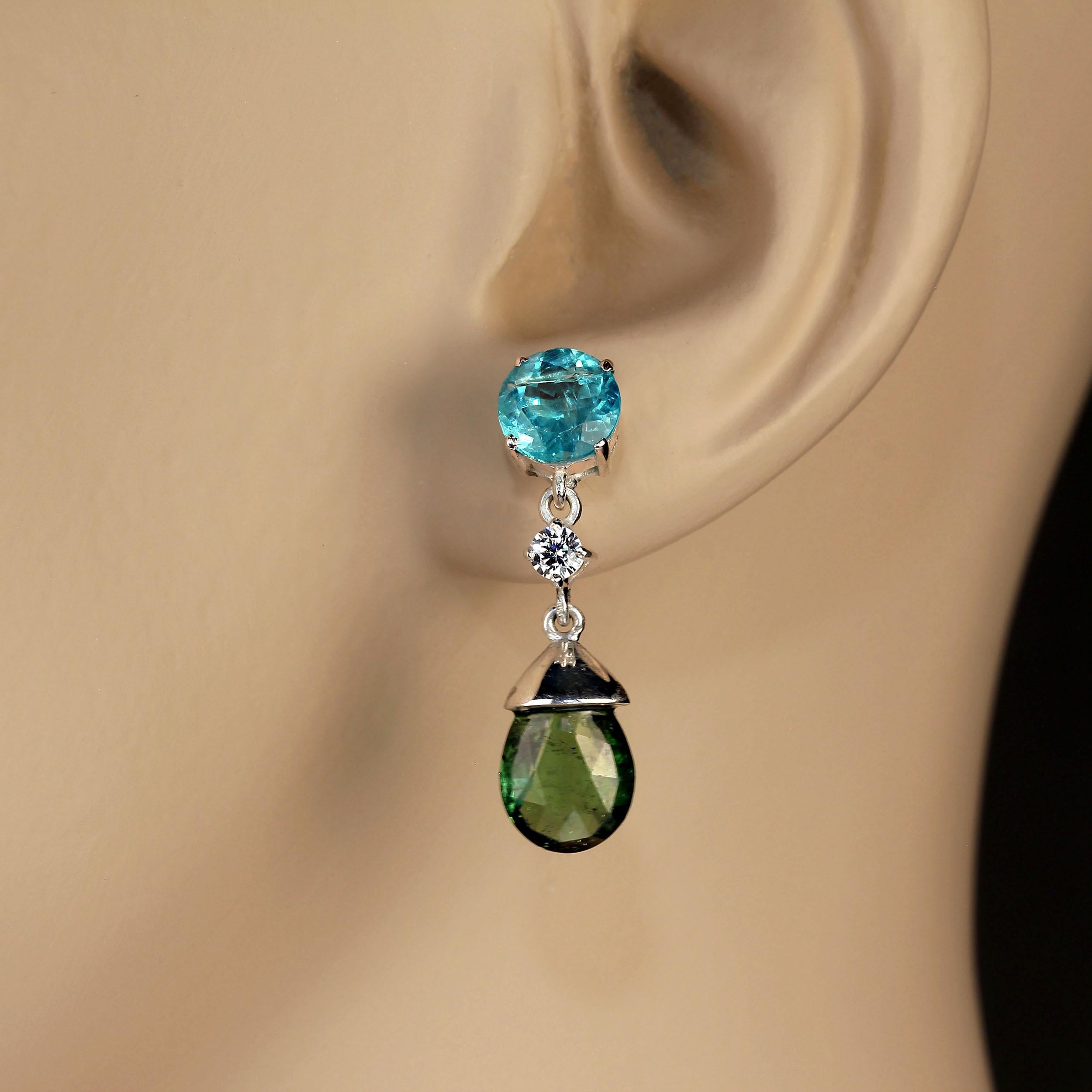 Dangle earrings of sparkling Blue Topaz and deep green Tourmaline.  These lovely dangle earrings have a drop of of 1 inch. The Blue Topaz have a total carat weight of 4.6cts and the green Tourmaline have a total carat weight of 9.61ct.  Genuine
