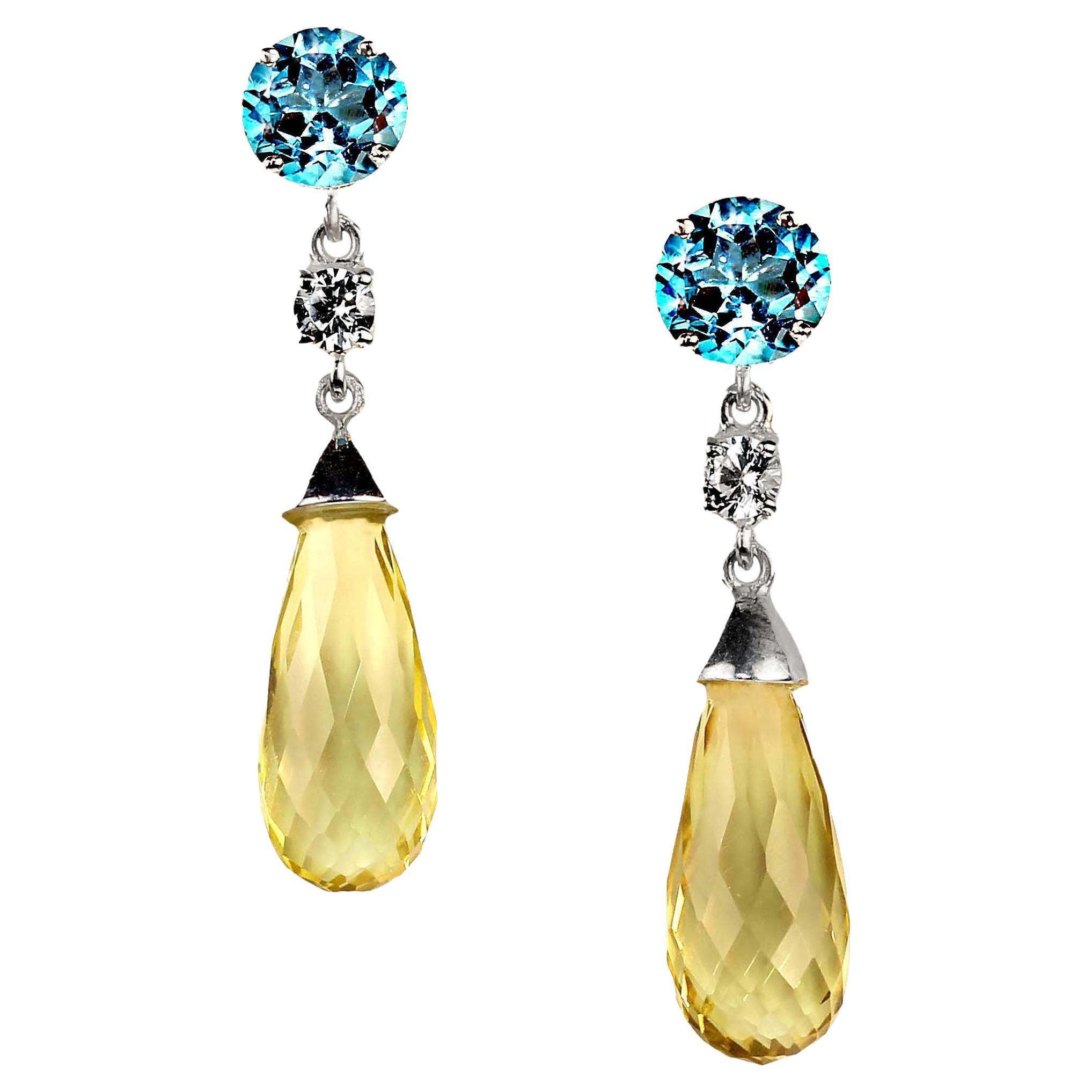 Sparkling dangle earrings of Blue Topaz and Lemon Quartz.  These lovely earrings feature round Blue Topaz of 3.44ct and Lemon Quartz briolettes of 13.35ct.  These are accented with 0.59ct of genuine zircon.  The setting is Sterling Silver with post