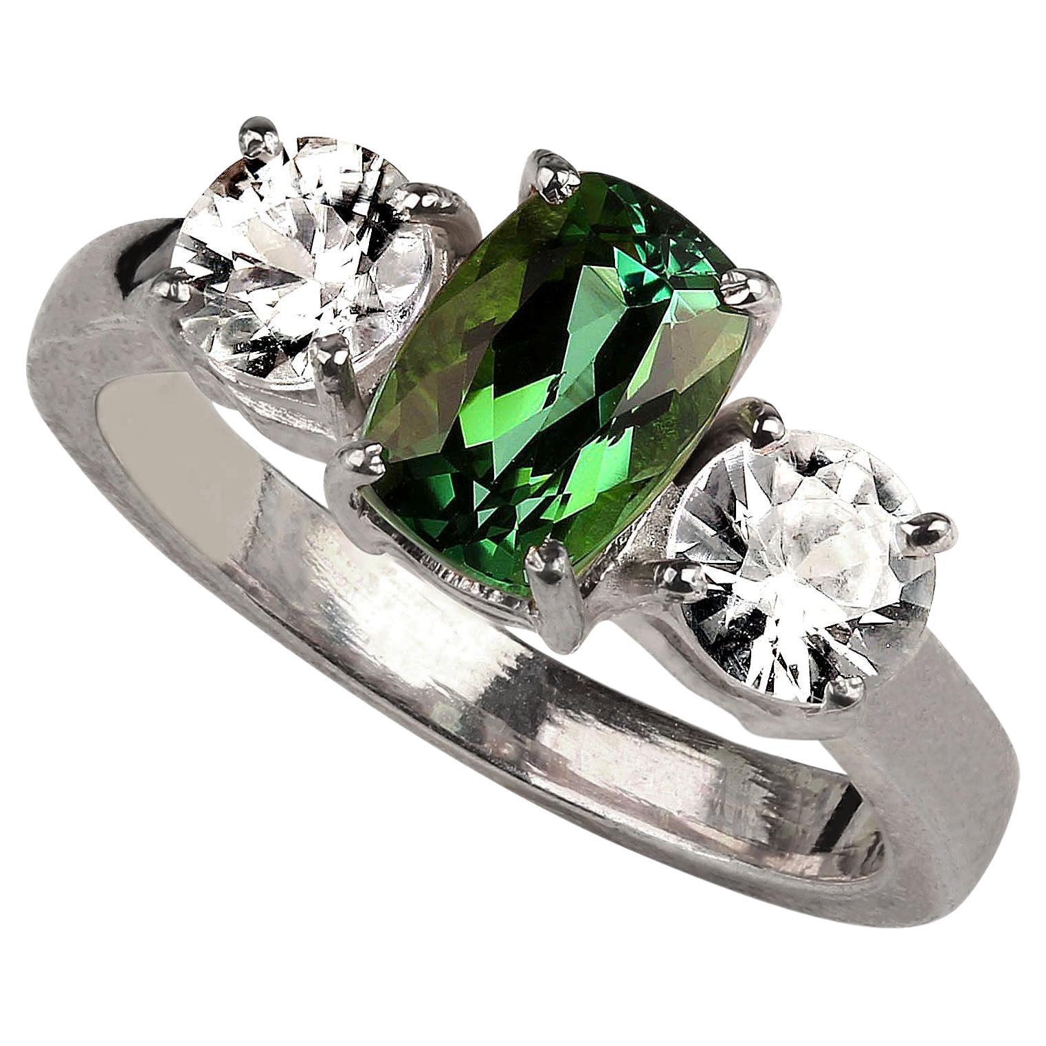 Gorgeous ring of brazilian oval green Tourmaline, 1.68 carats accented with two round genuine zircons, 1.44 ctw. It's difficult to say which sparkles more, the tourmaline or the zircons! This is a gorgeous ring. The Tourmaline came from one of our