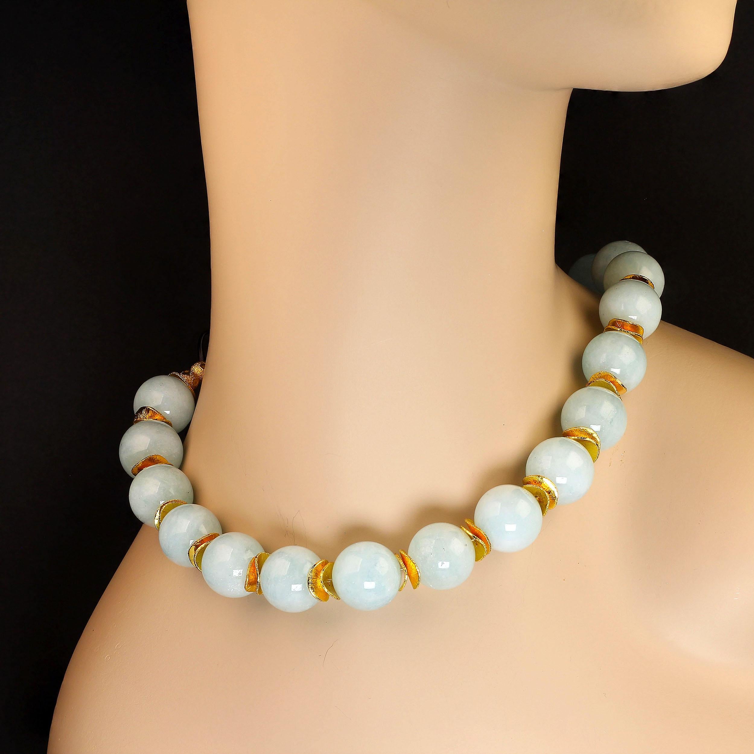 Elegant and unique, this 'aqua' toned large scale Aquamarine choker necklace makes such a great statement surrounding your neck. The 15-16 MM highly polished Aquamarine is enhanced with brushed goldy tone flutters. This 16 inch necklace features an