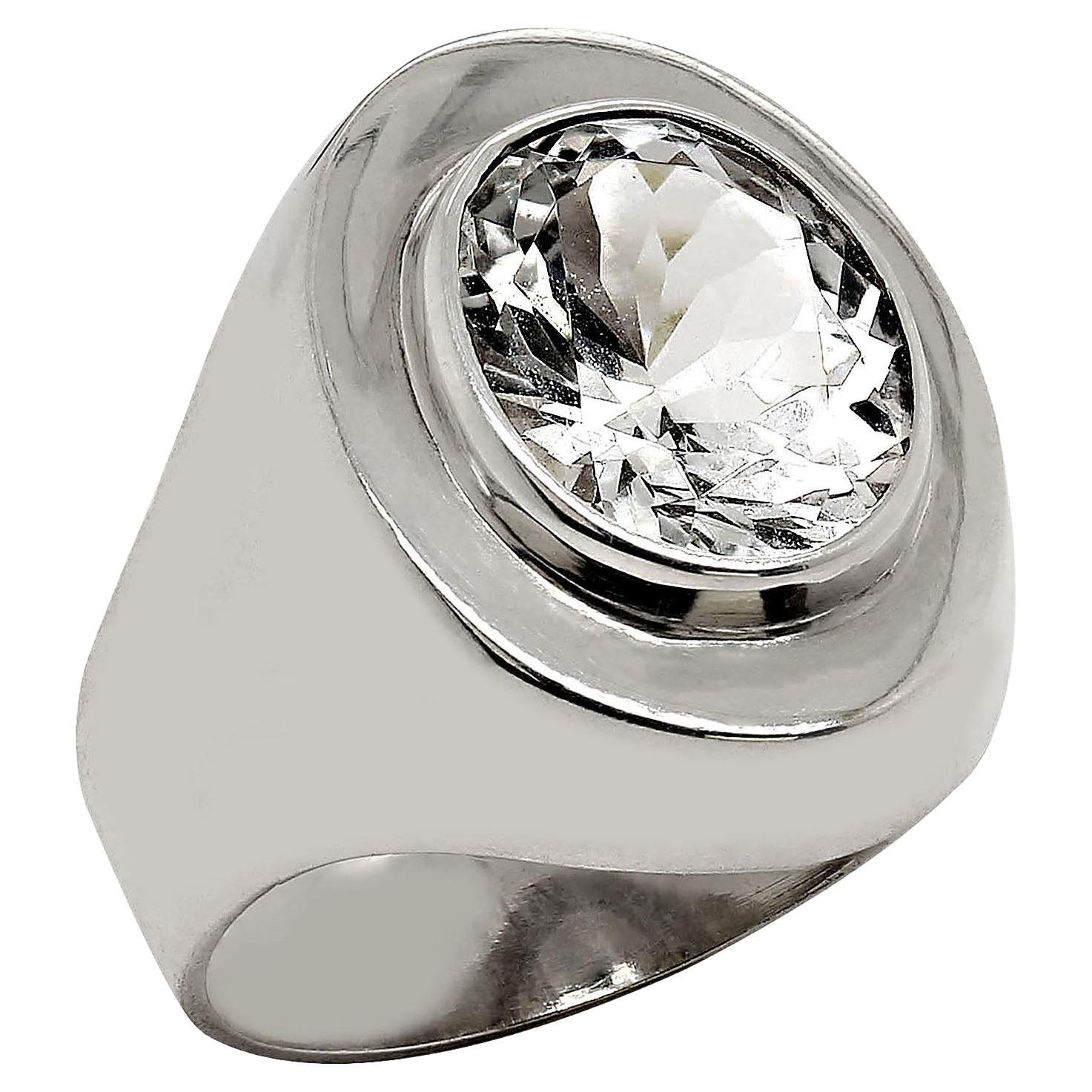 Sparkling Oval Silver Topaz Set in Handmade Sterling Silver ring.  This is a lovely ring designed and created by one of our artisans in our mountain studio outside of Rio de Janeiro.  The full shank rises up to Flat surface with oval Bezel Set