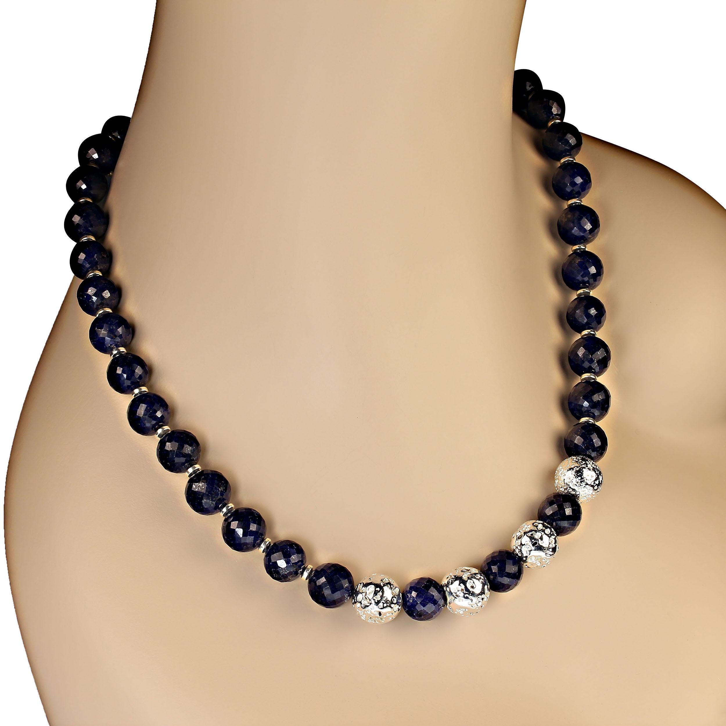 21 Inch blue sapphire necklace with silver lava rock focal accents.  These 11 mm blue sapphire beads are faceted and sparkle blue as they catch the light.  The silver accents between them also reflect light. There are four 13 mm silver lava rock