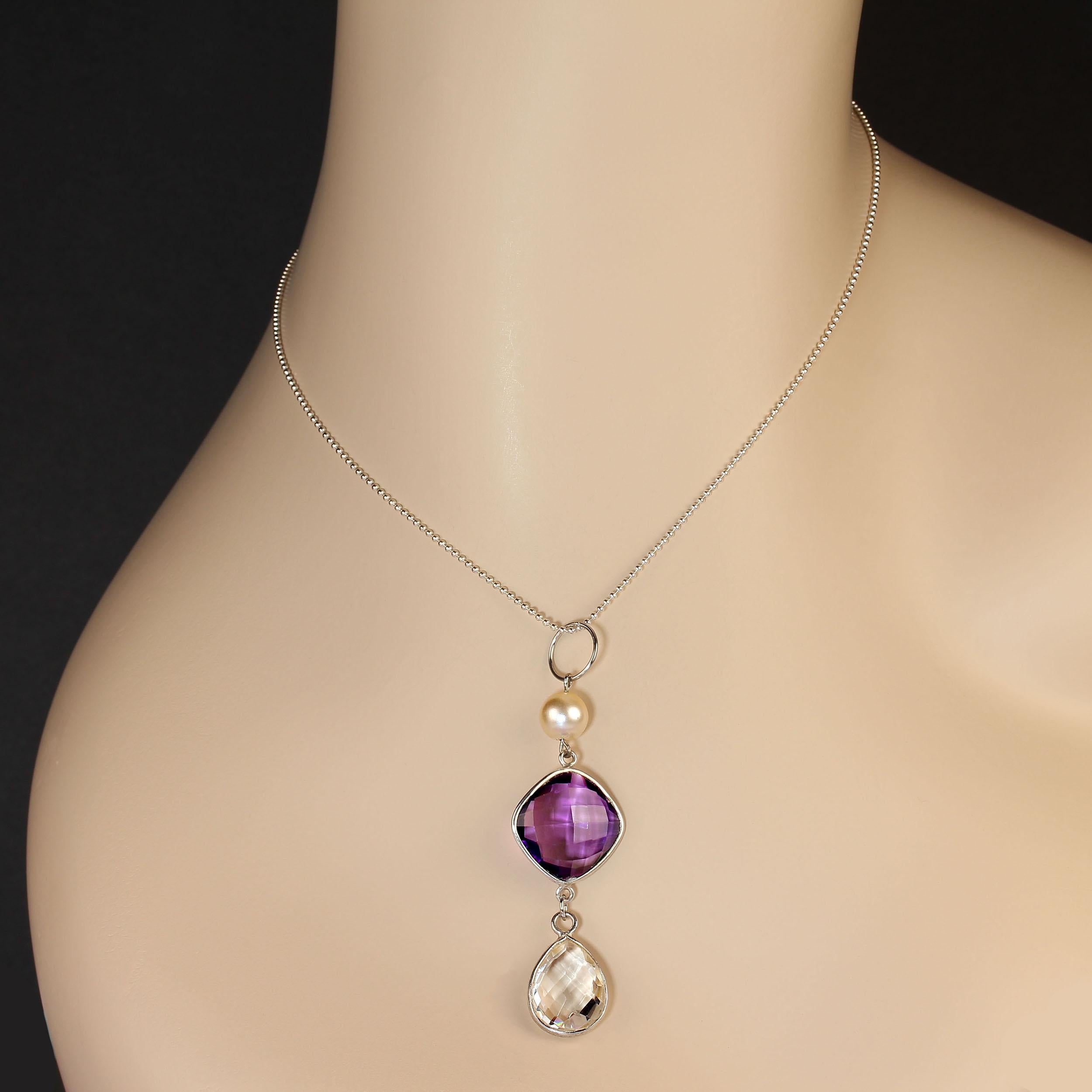 Custom made pendant which features a glowing pearl atop a checkerboard cut amethyst and suspended from that a checkerboard cut quartz crystal! There is lots of movement in this colorful pendant. The stones are bezel set in silver tone and the bail