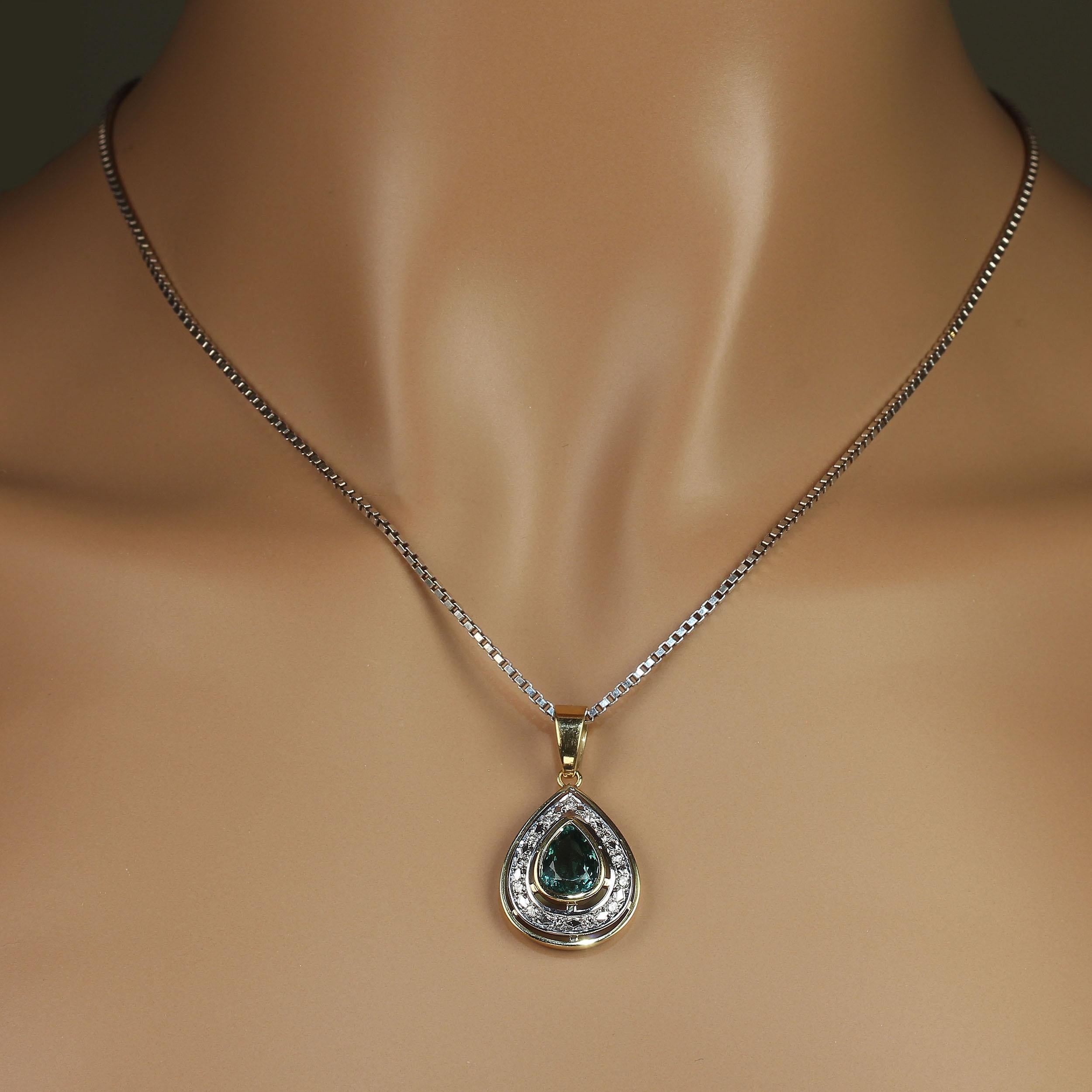 So much pizazz in this pendant! A gorgeous pear shaped, bezel set sparkling Green Quartz is the center of this unique pendant. That is encircled with row of diamonds in white gold, and then another edge of yellow gold. This Brazilian hand made 18K
