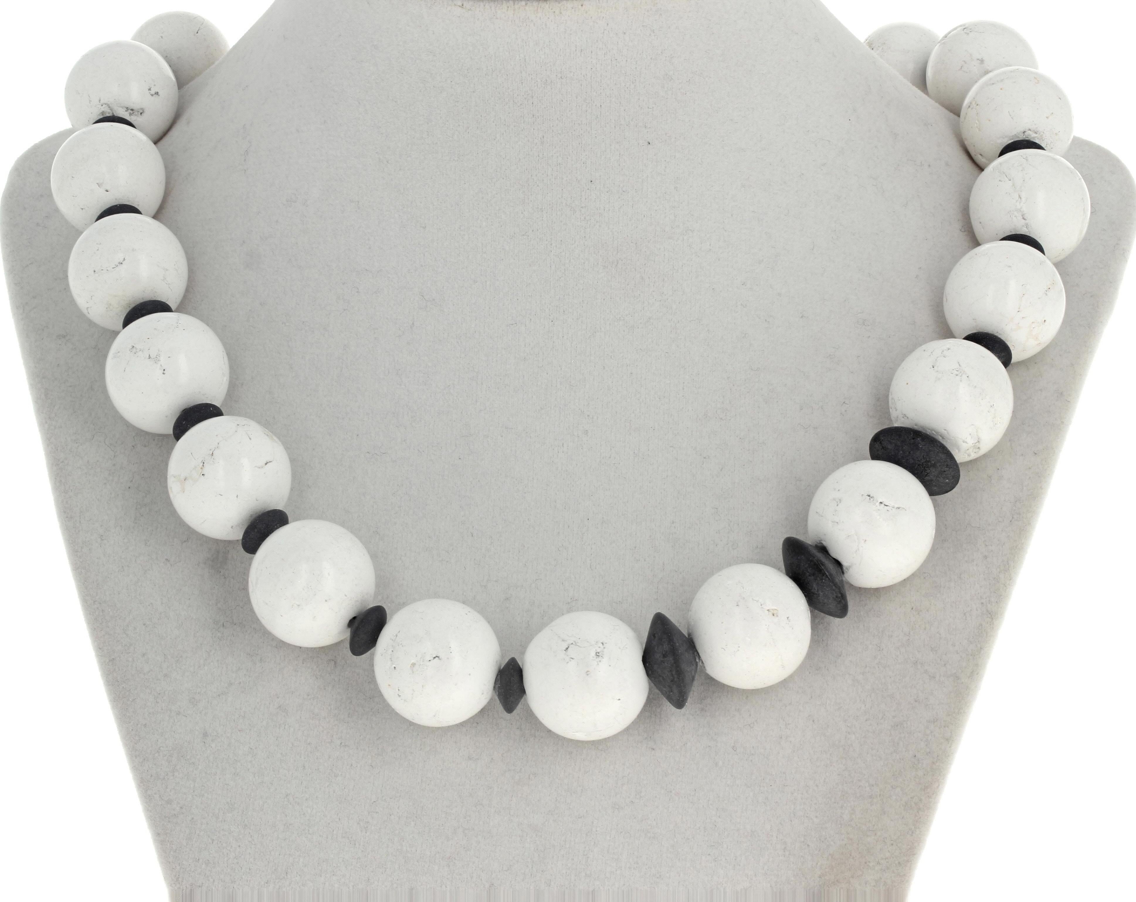 These lovely white natural Magnesites (approximately 18mm) are enhanced with the interestingly gem cut natural black Onyx (largest approximately 14mm).  This elegant necklace is 19 inches long and the clasp is an easy to use slide-in gold clasp.