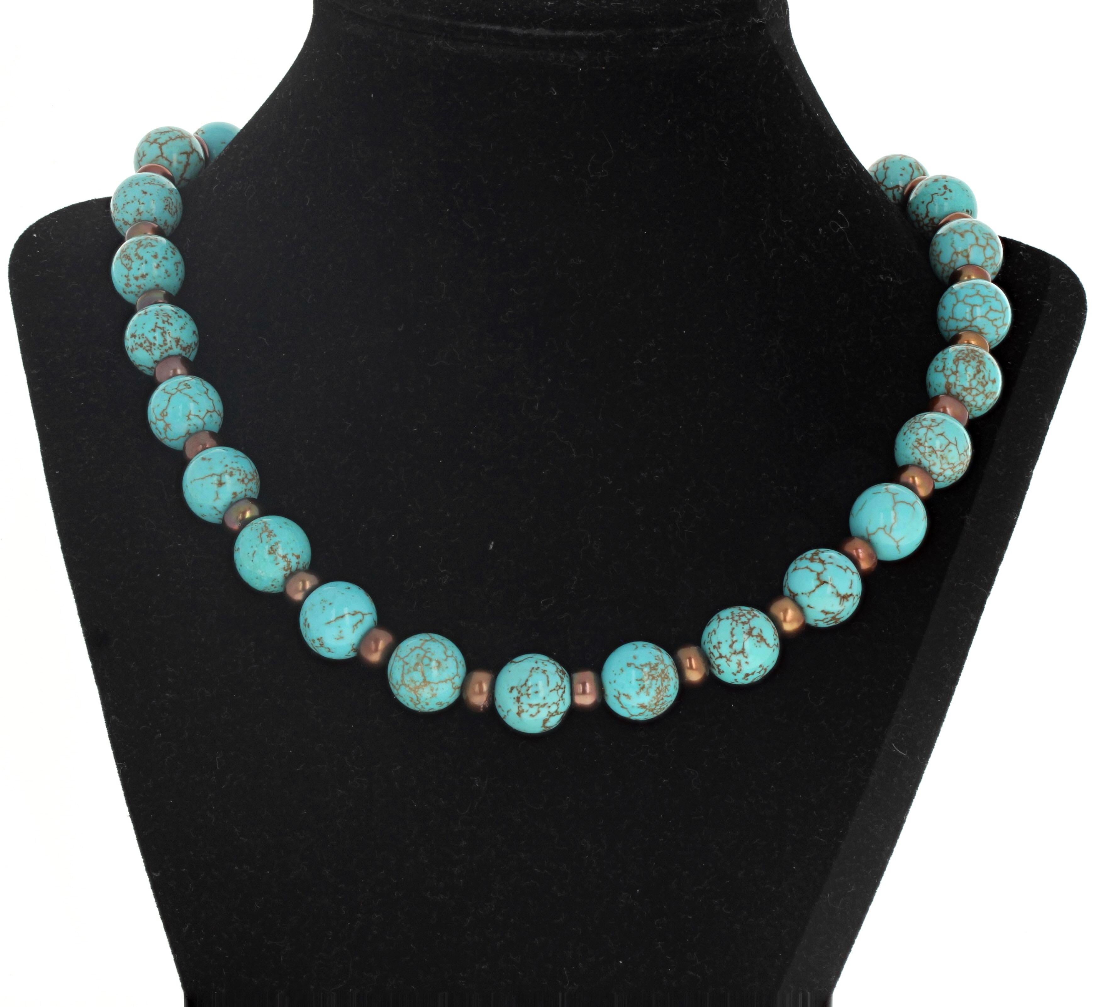 Natural highly polished blue Magnesite (approximately 12mm) is enhanced with natural rare goldy brownish coral rondels (approximately 7mm) in this lovely  18 inch long necklace.  The clasp is an easy to us silver hook clasp.