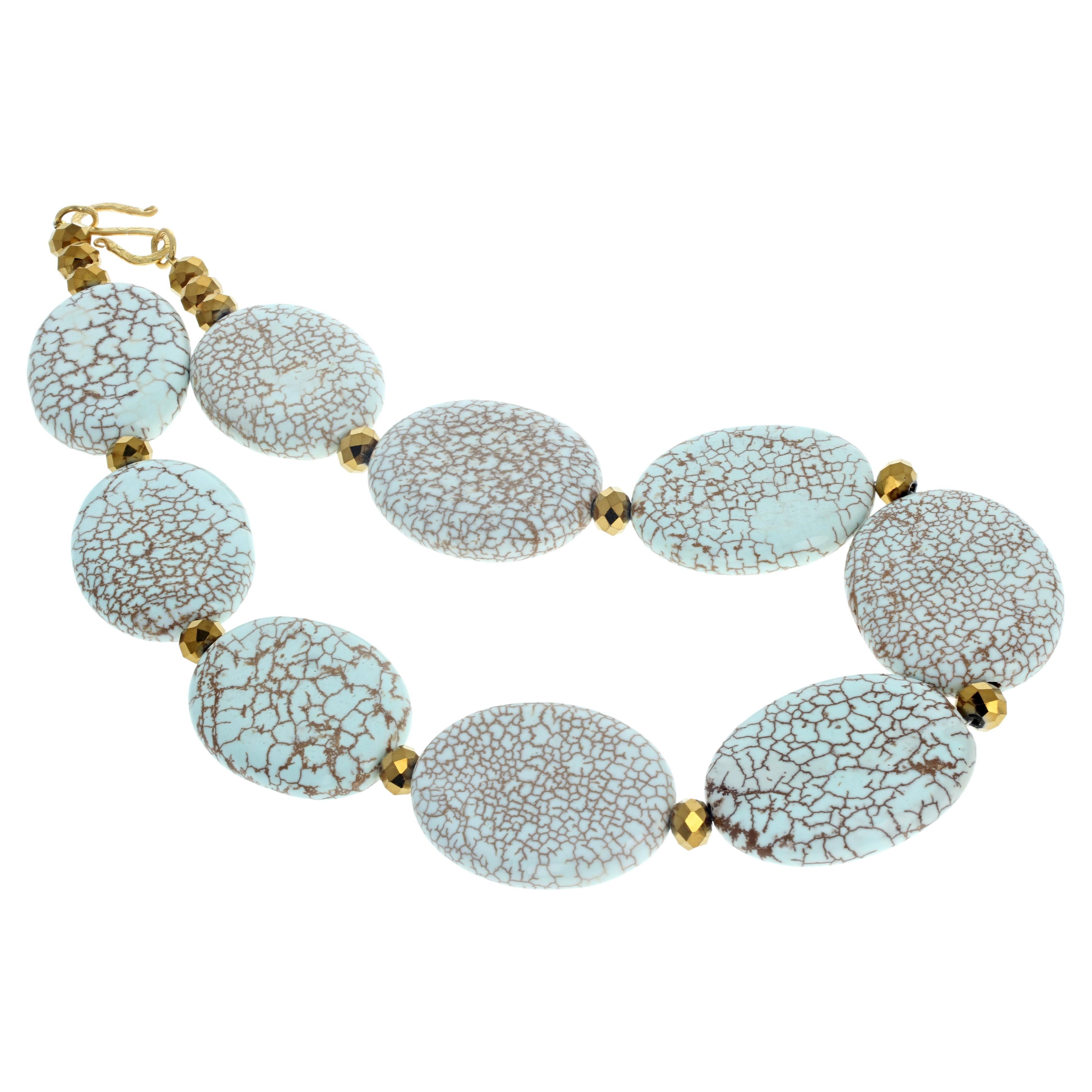 This interesting real natural Magnesite (approximately 20mm x 40mm) is set with goldy plated multi-faceted rondels (approximately 8mm) to show off the natural qualities of the Magnesites.  This fun-to-wear necklace  is 18 1/2inches long with an easy