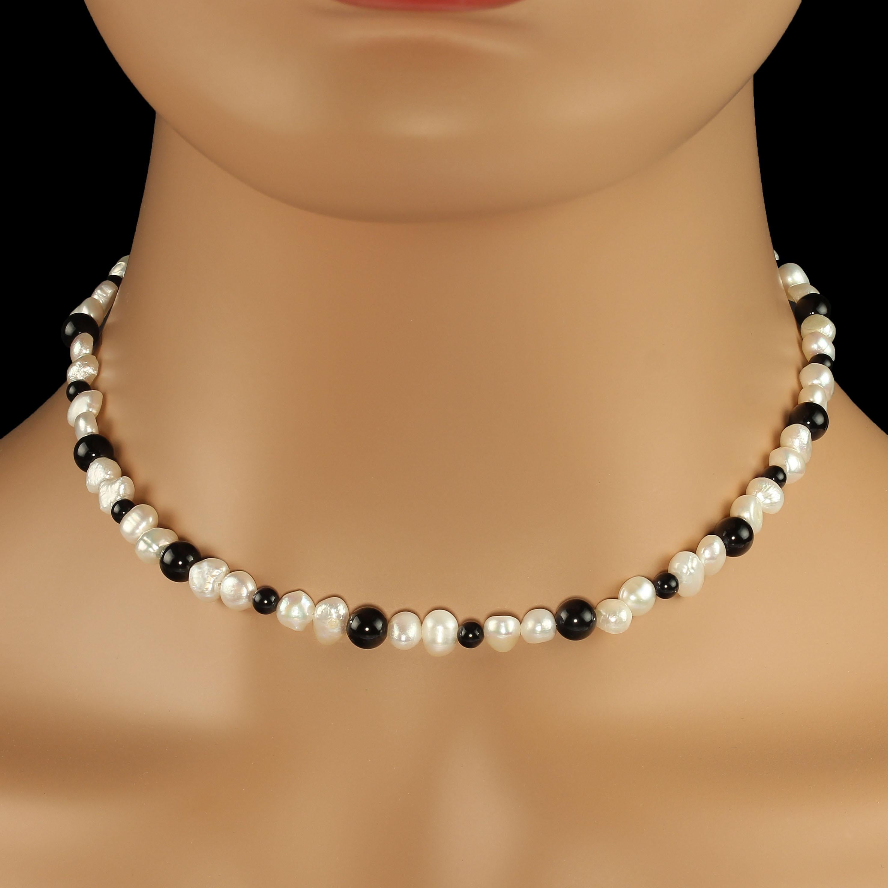 'Put on your Pearls Girls'  Lulu Guinness

Handmade Black and White Choker Necklace of White Freshwater Pearls and Black Onyx in a delicate 15 inch choker length. The lovely iridescent free form Freshwater pearls are mostly roundish and contrast