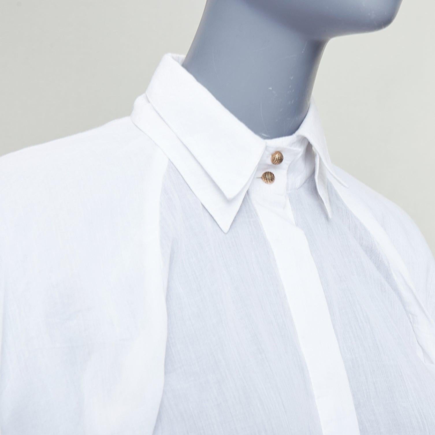 AJE white cotton Victorian puff sleeve double collar shirt UK6 XS
Reference: CNLE/A00401
Brand: Aje
Material: Cotton
Color: White, Gold
Pattern: Solid
Closure: Button
Extra Details: Hidden button stand.
Made in: India

CONDITION:
Condition: