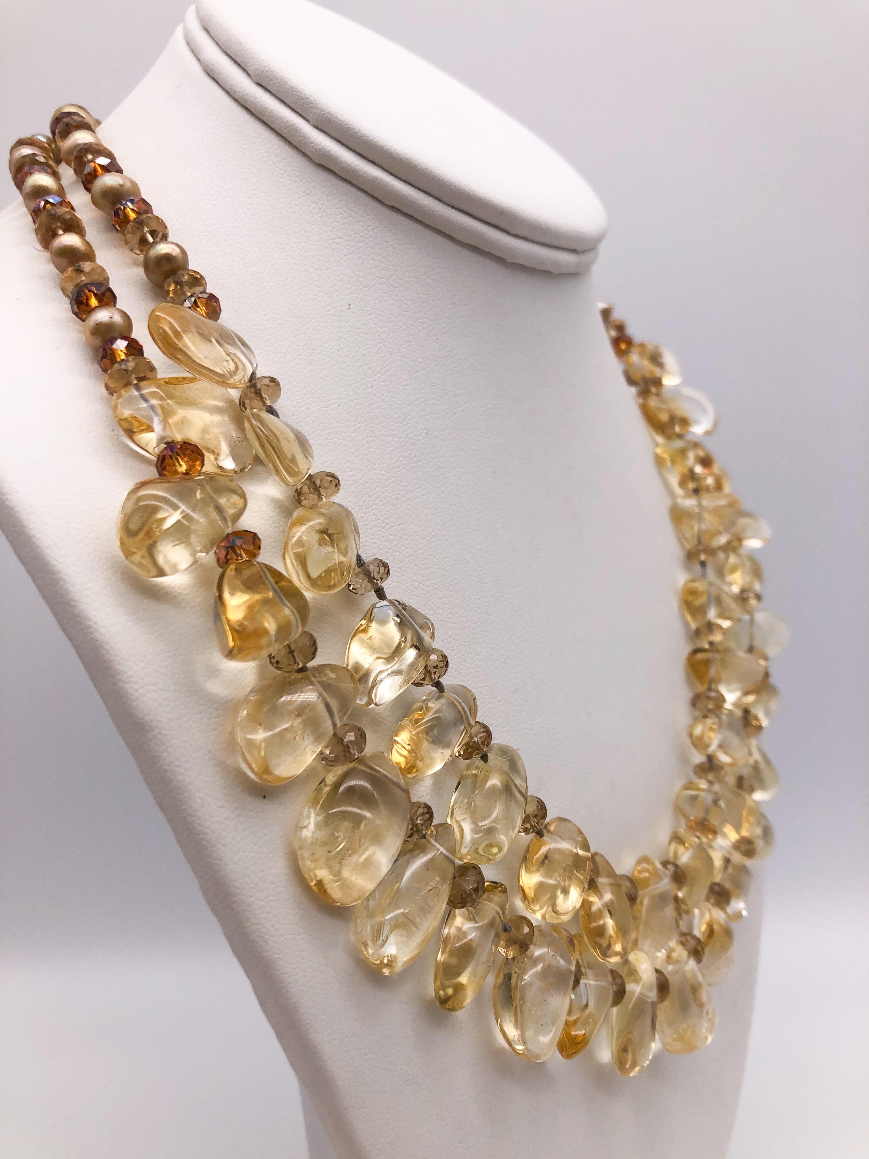 One-of-a-Kind

A double strand of transparent, polished, citrine drops.  From collar bone to collar bone the citrine stones are met by a double strand of faceted topaz citrine beads and gold pearls. The slim strands allow for a comfortable yet