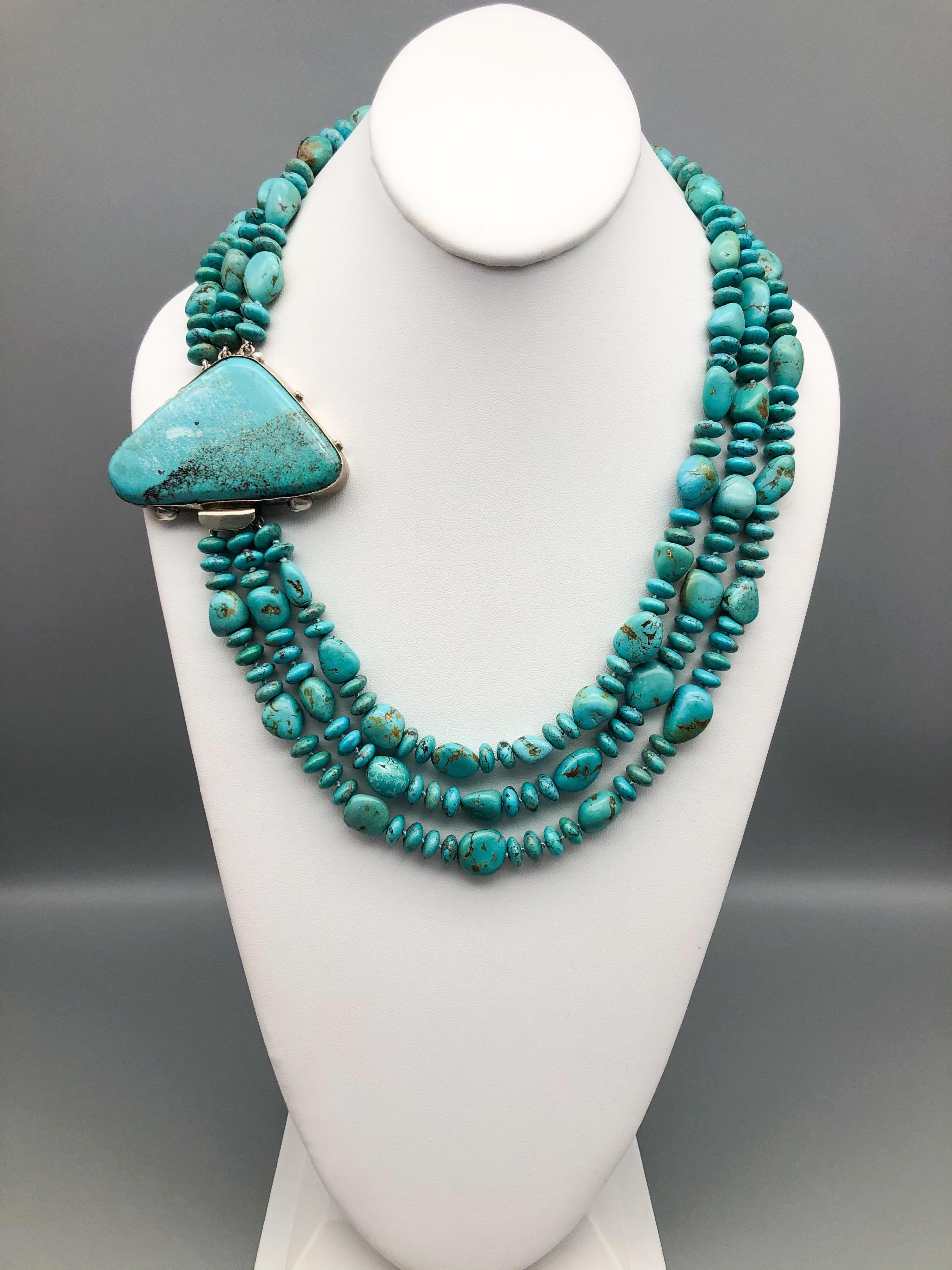 One-of-a-Kind 
3 strand natural American Kingman mine Turquoise necklace with 3”x2” hunk of Turquoise fastener.
The beautiful triangular-shaped Turquoise clasp is the centerpiece of this necklace. A specimen from the Kingman mines measuring 3”x2”