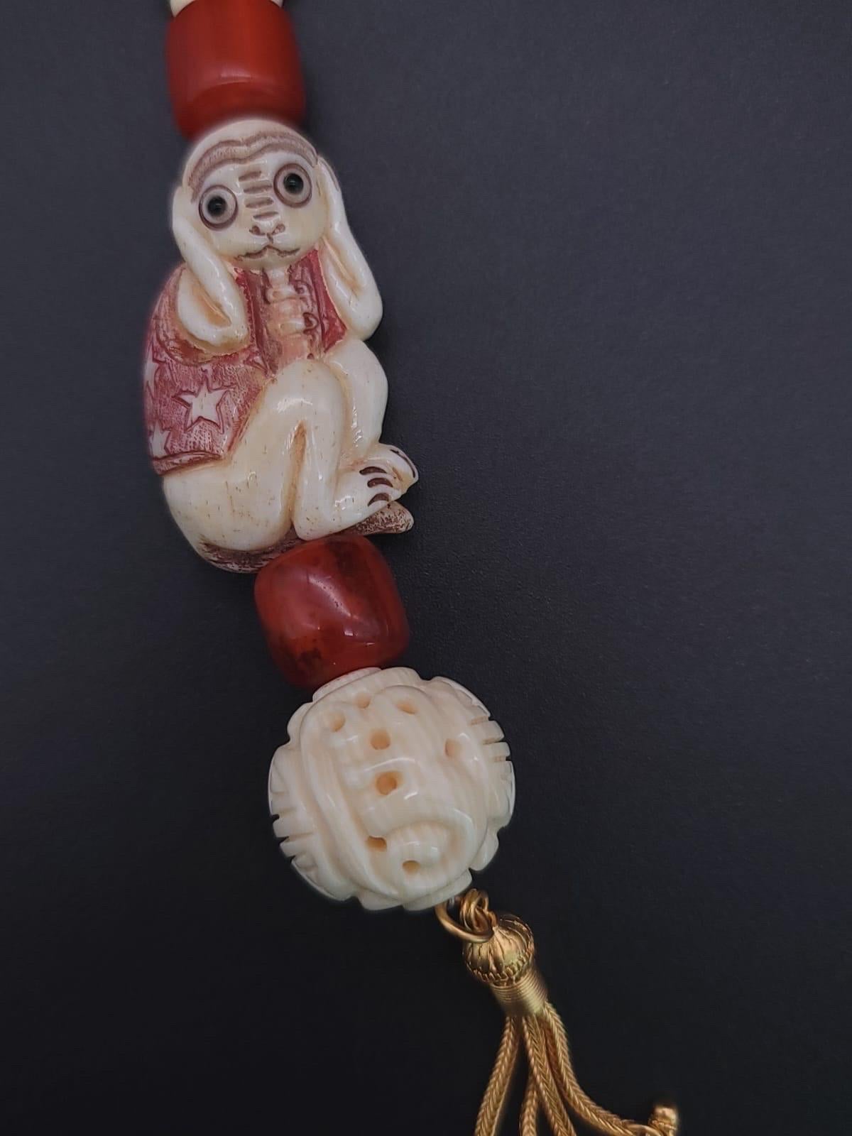 Mixed Cut A.Jeschel 3 Wise monkeys in a Long Red Copal necklace  For Sale