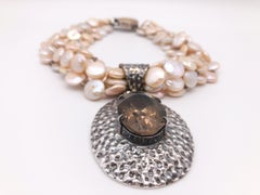 A.Jeschel 5 strand coin pearl necklace and Smokey Quartz necklace.