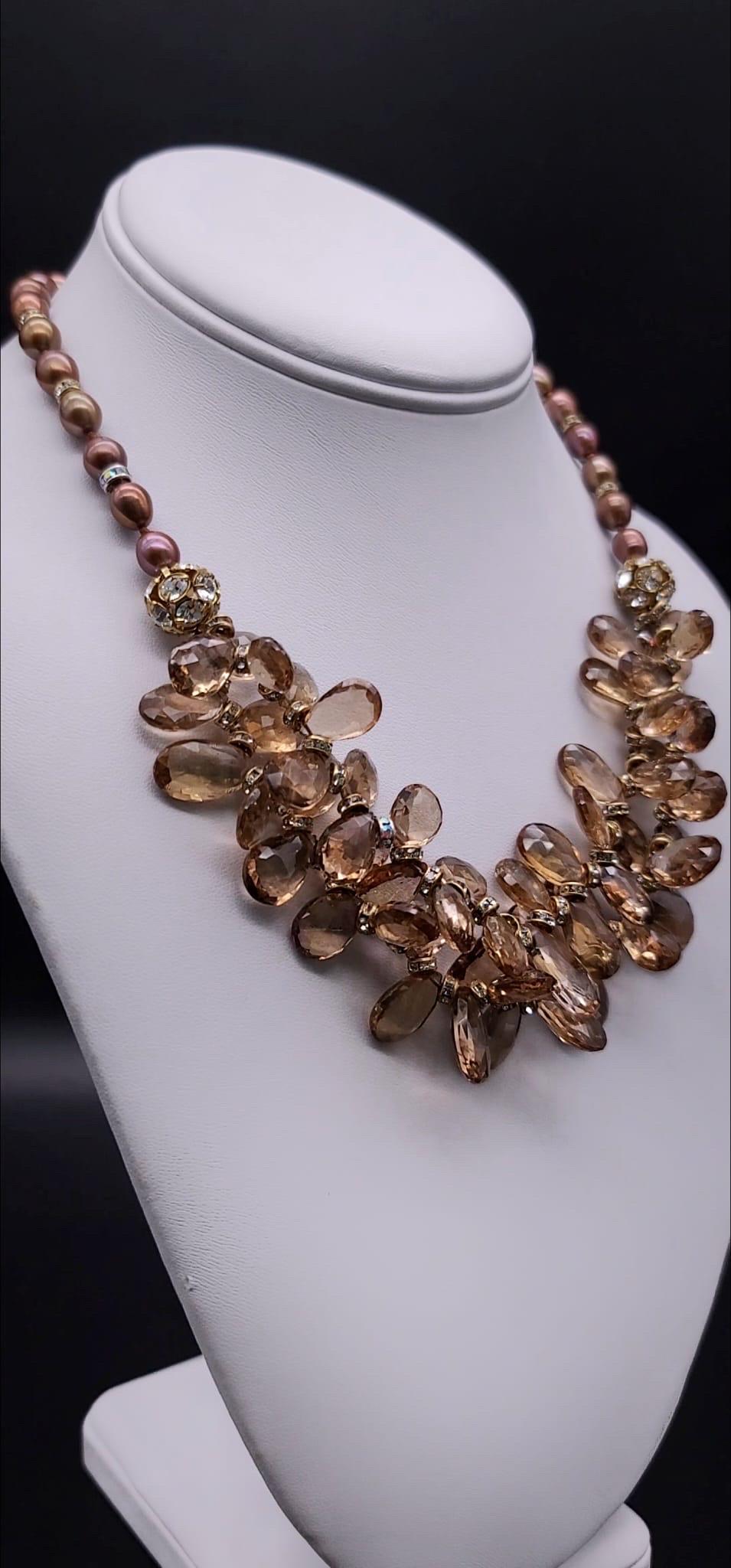 One-of-a-Kind

A dramatic mix of faceted champagne quartz teardrops in a 2 strand cluster is suspended from an 8m.m. gold pearl  necklace accented with small vermeil and C.Z. Rondels.
The vermeil (22k gold) over Sterling Silver clasp inset with a