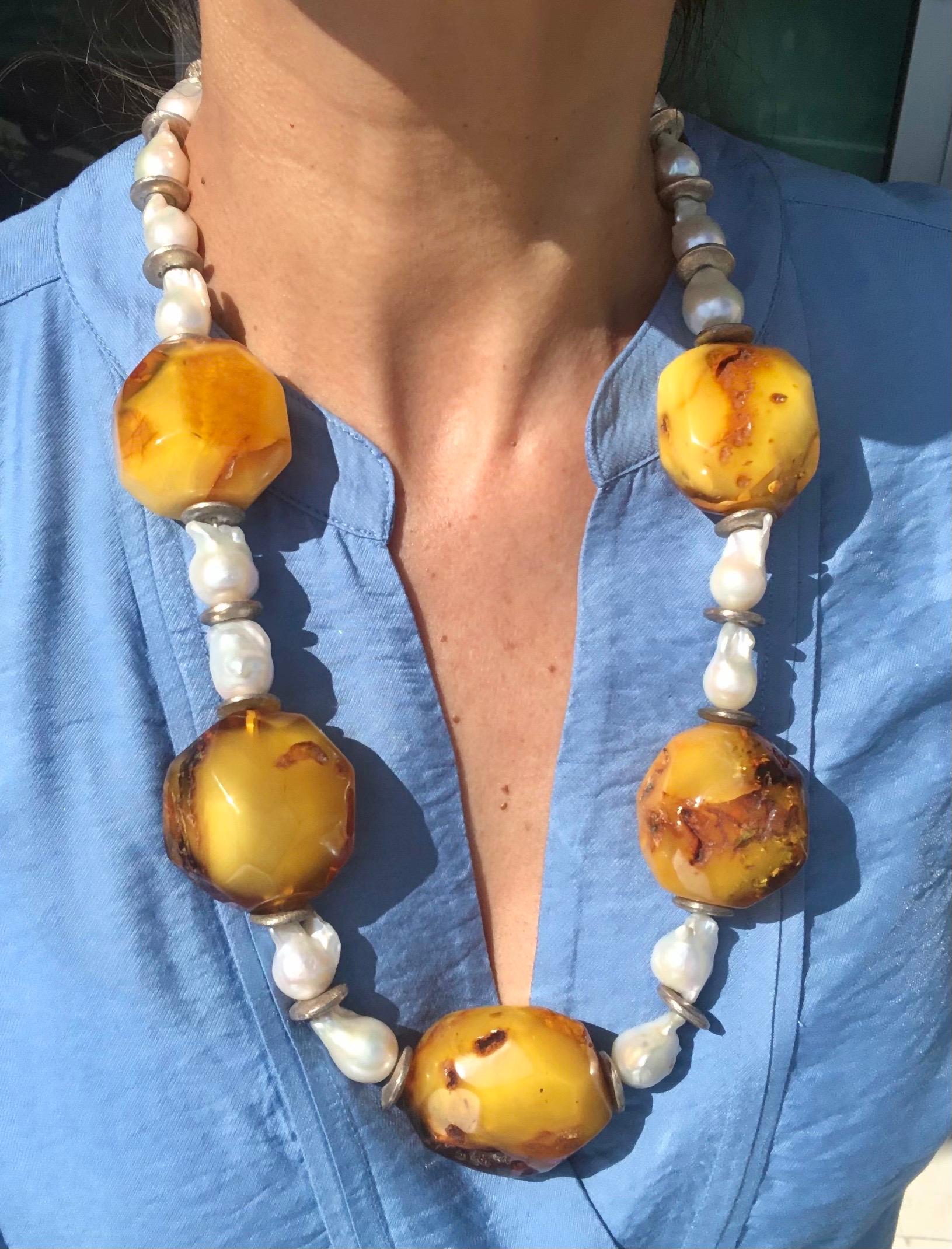 One-of-a-Kind

Introducing a stunning piece of jewelry that combines two unique and captivating materials - a big and bold necklace featuring Amber and Baroque Pearls.

While Amber is not technically a gemstone, it is a fossilized tree resin that
