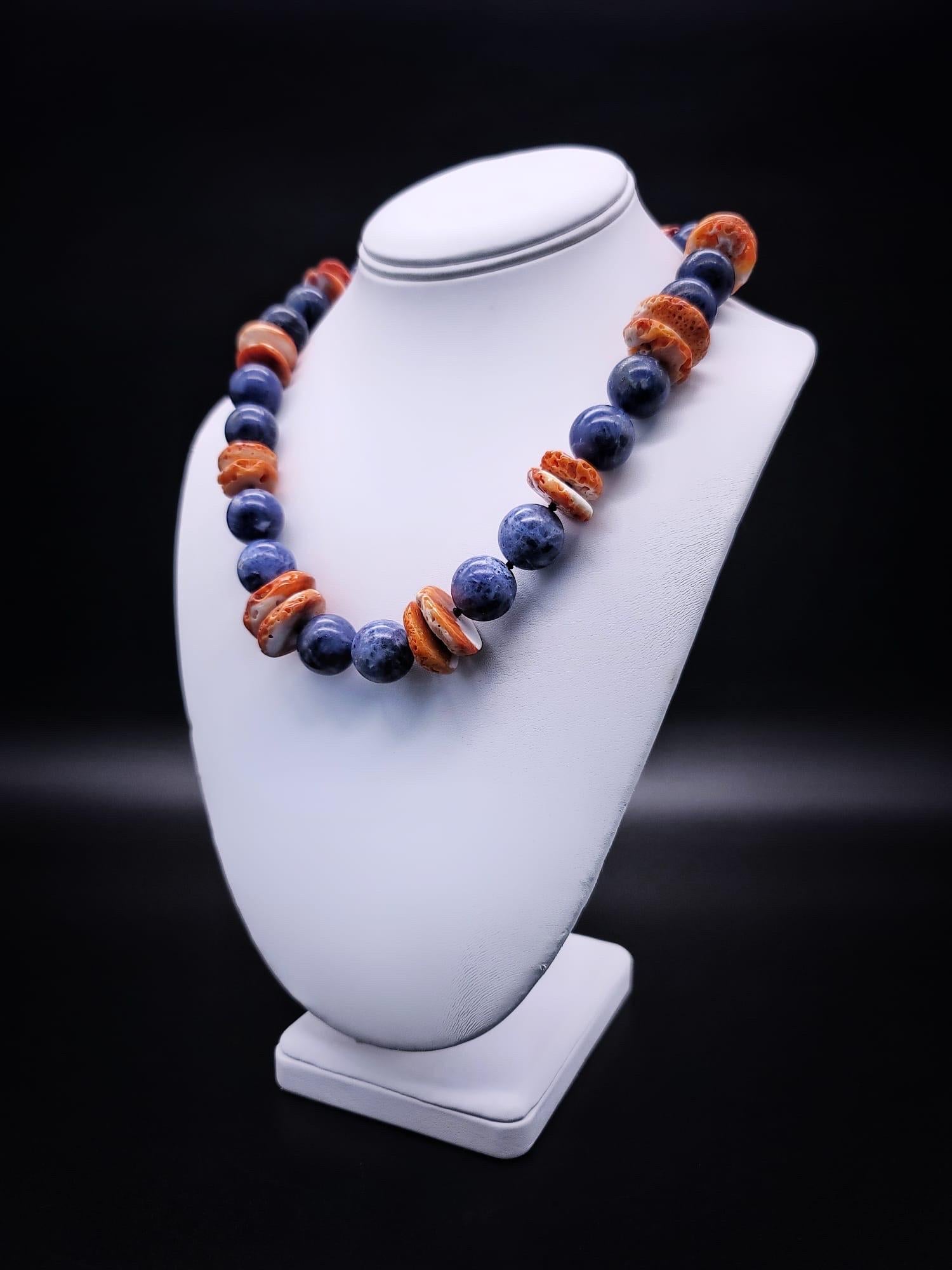 One-of-a-Kind 

A gift from the sea. 
Mexican spiney shell oyster mixed with 16m.m denim Blue Coral beads in a not-so-simple single strand. The clasp is a replica of the buttons worn by the Vatican guards.

Blue Coral boosts psychic awareness and