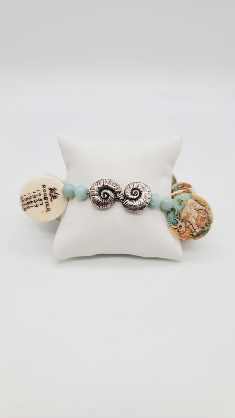 One-of-a-Kind
Good fortune in the year of the tiger!
Bracelet hand-painted Chinese Zodiac carved bone discs, polished Amazonite beads.
Clasp Sterling Silver 
Approx: 7.5'