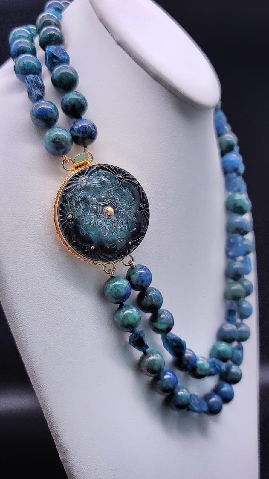 One-of-a-Kind

A mixture of nature's best blue/green stones Chrysacolla and Apatite. The 12 m.m. Polished Chrysocolla is interrupted by nuggets of rough-cut Apatite. A slightly more porous and therefore light-reflecting bead. The side-clasp of