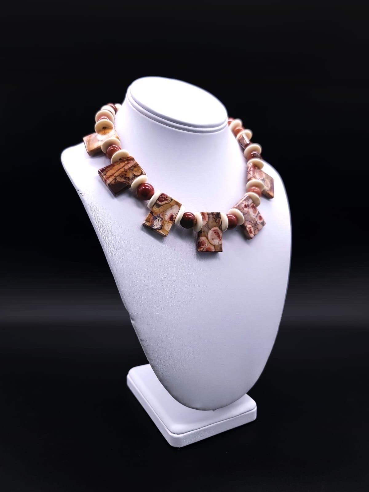 One-of-a-Kind

This necklace boasts a remarkable fusion of Corallia Jasper encircled by Aventurine beads and Fossil walrus bone in a harmonious blend echoing the centuries in the natural order. The polished stone, an agatized Jasper, creates a