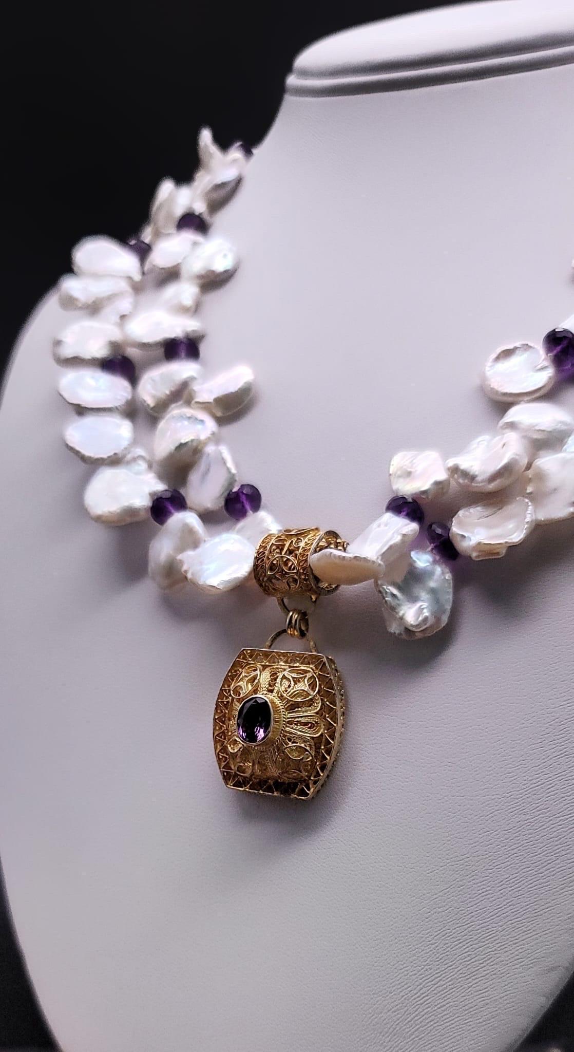 One-of-a-Kind

Twisted Keshi Pearl and Amethyst double strand necklace anchored by a wonderful vermeil filagree and Amethyst pendant designed by Barbara Garwood and handmade, under her supervision, by craftswomen in a small village near Chinese