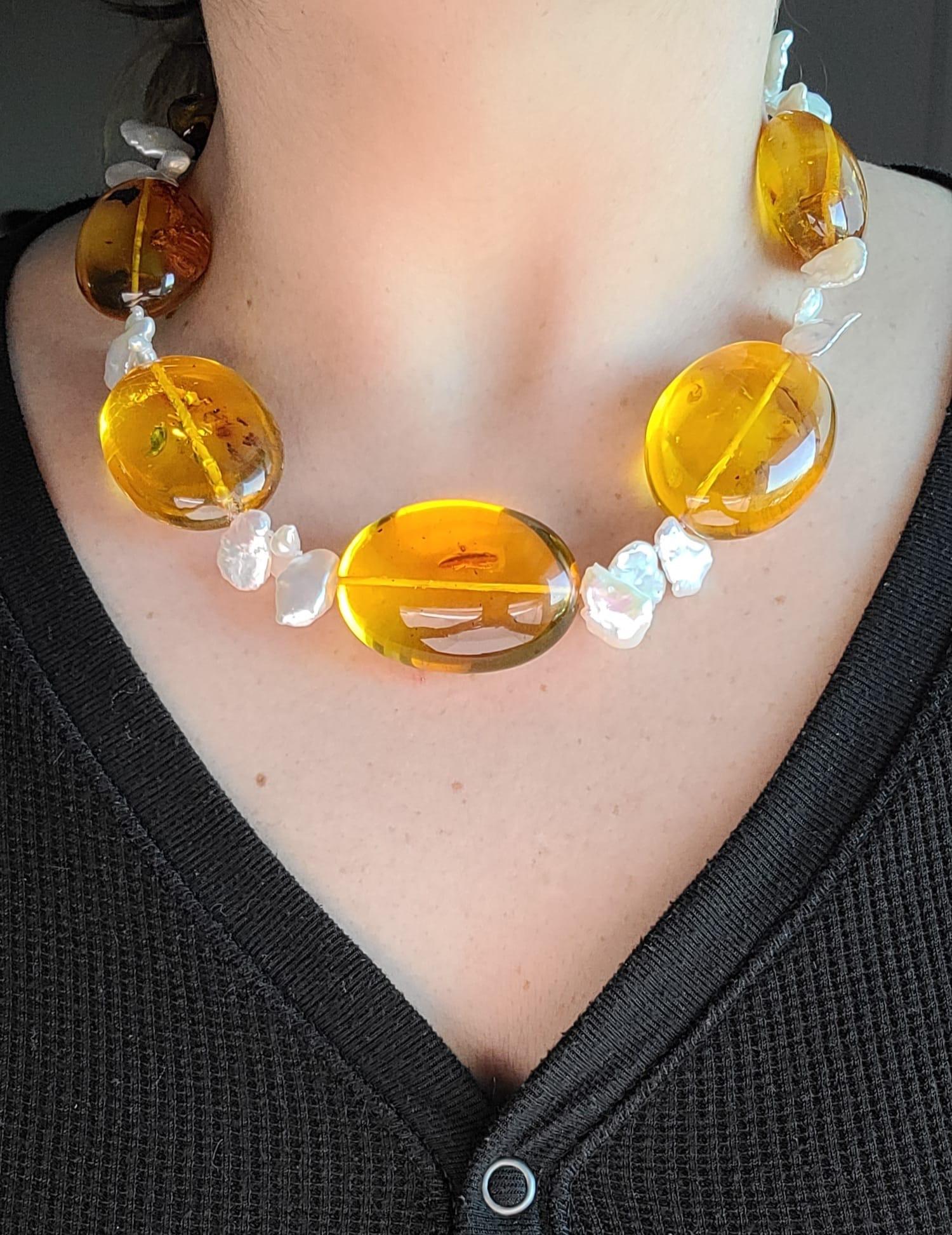  A True One-of-a-Kind Gem

Prepare to be captivated by the unparalleled beauty of this unique necklace. Meticulously crafted, it combines the ethereal allure of fine, transparent Baltic Amber, adorned with distinctive inclusions that tell a story of