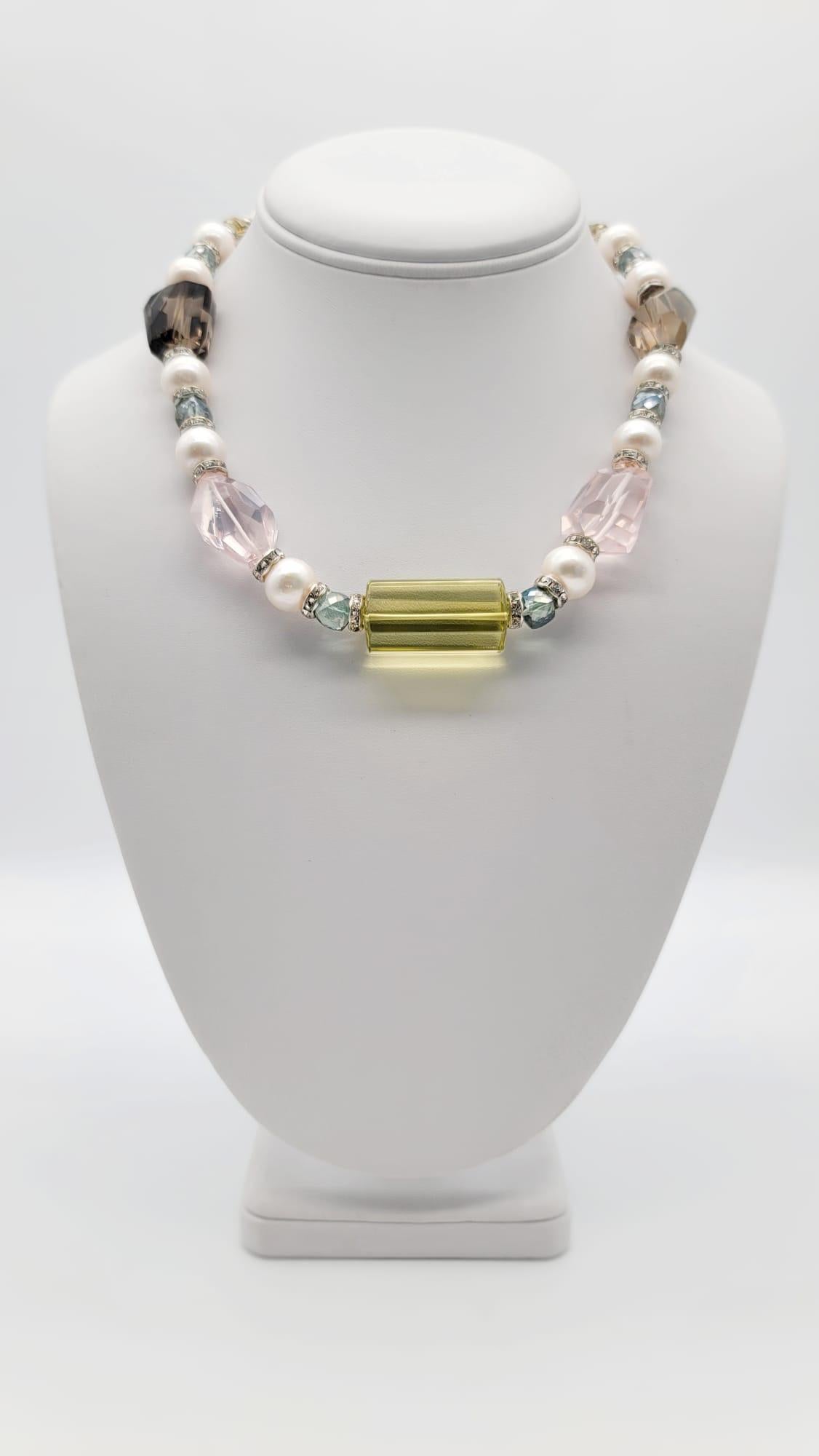 One-of-a-Kind

Elegant crystal quart in a soft and flattering palette of Citrine, Rose Quartz, Smokey Quartz, and Aquamarine all spaced between 10mm Pearls, CZ roundels.
The necklace is centered with an elongated barrel-cut citrine followed by rose