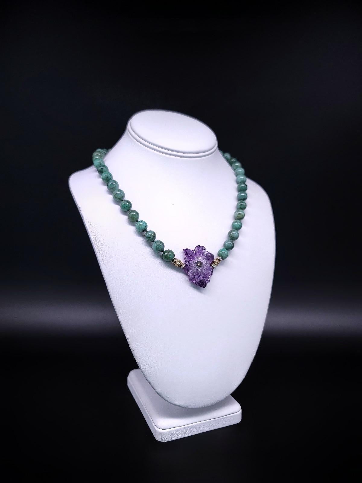 Discover the extraordinary with our one-of-a-kind necklace featuring Brazilian Emerald polished beads, a Vermeil pendant showcasing an Amethyst Stalactite sliced, and the  clasp adorned with Charoite set in Vermeil. Meticulously hand-knotted with