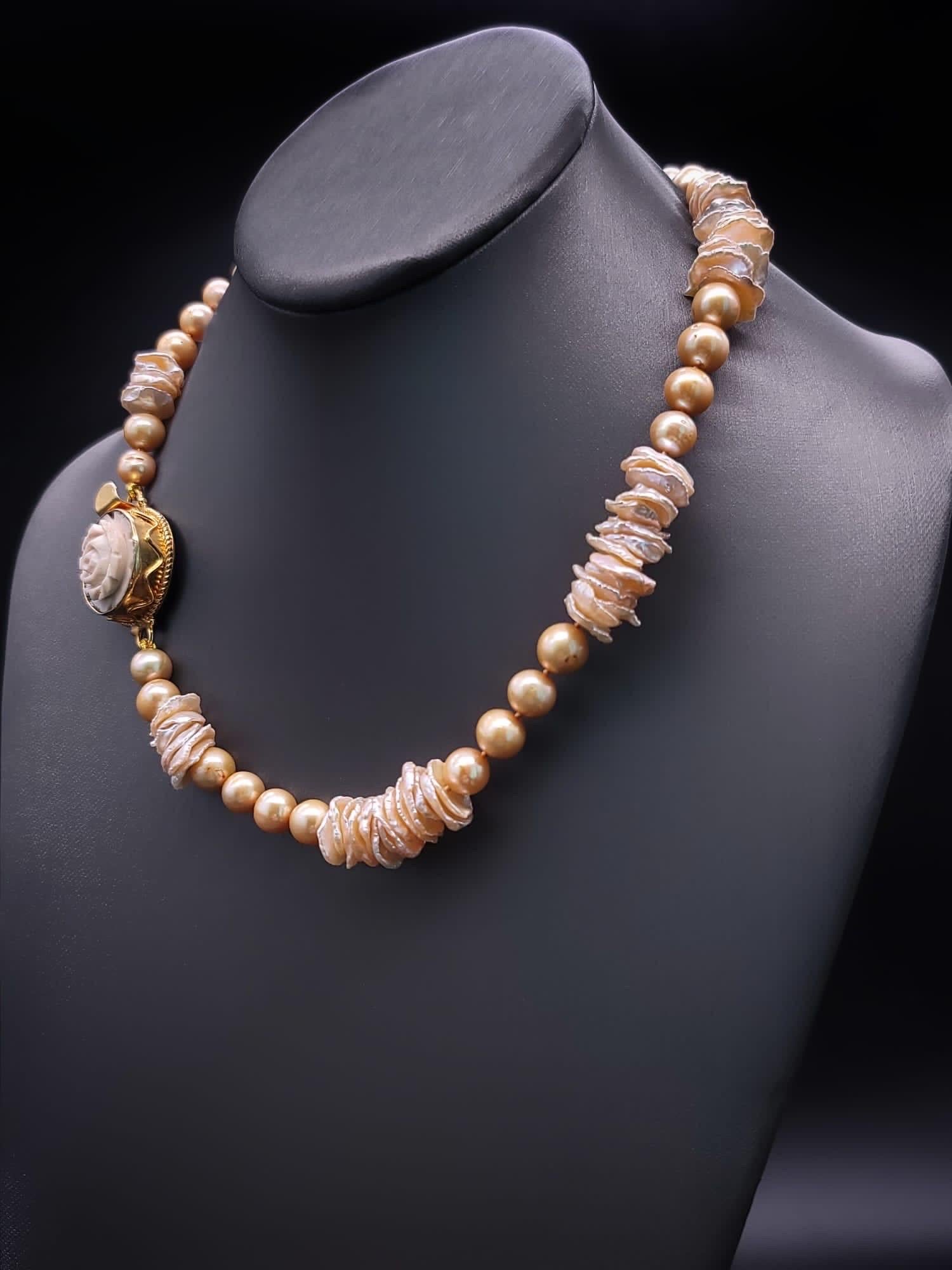  A Classic Fusion of Elegance and Uniqueness.

This stunning necklace is a timeless embodiment of grace, featuring lustrous freshwater gold pearls, each carefully selected to exude radiance and sophistication. Delicately interspersed are freshwater