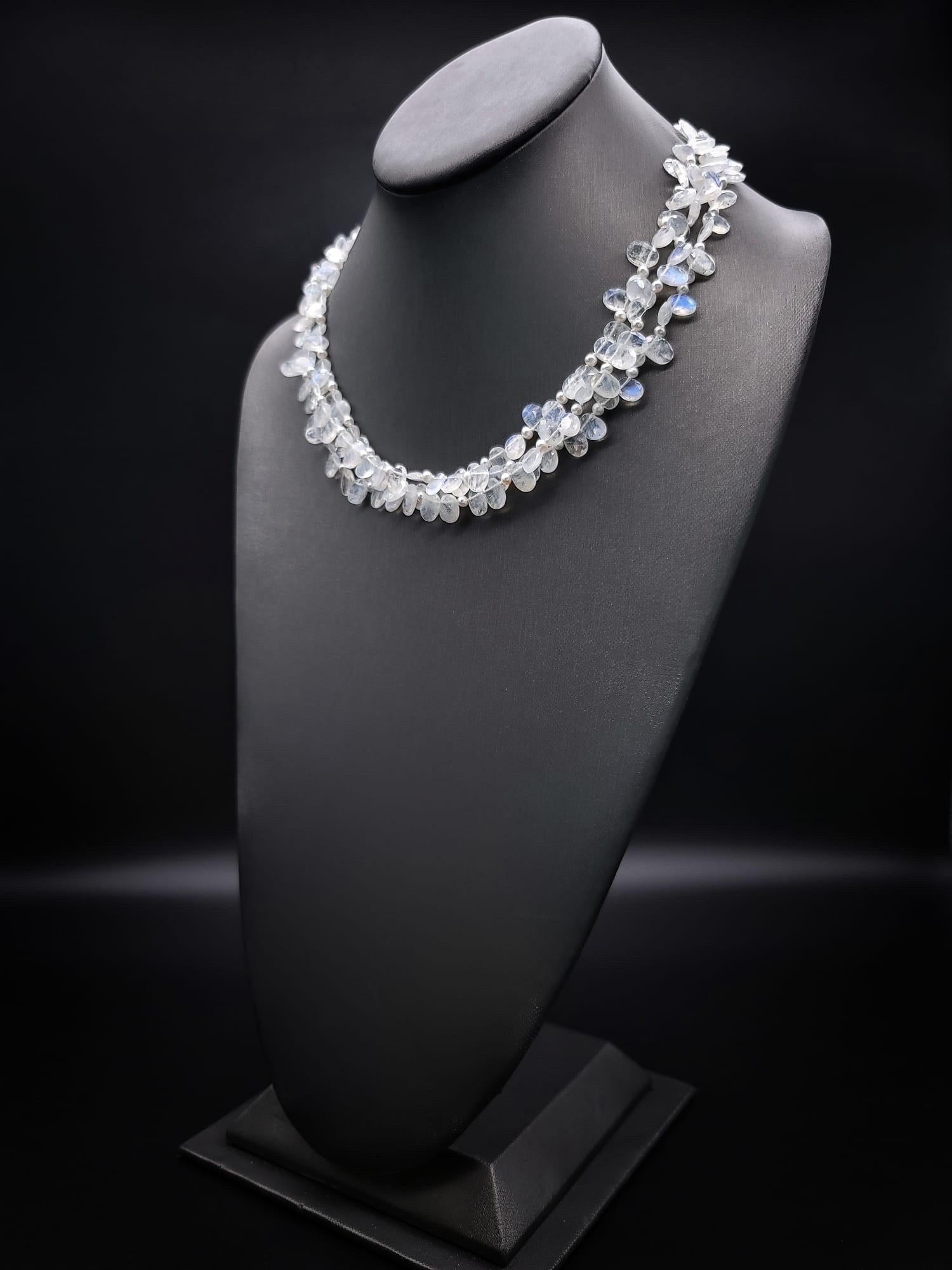 One-of-a-Kind

3 strands of facetted teardrop rainbow Moonstones separated by seed pearls in a softly, flattering necklace. The 3 strands are gathered by large (12-14m.m) pearls to keep the moonstones in place and anchored with a sterling silver box