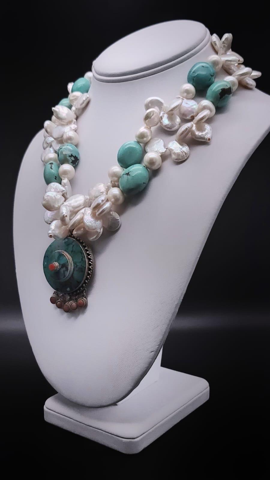 One-of-a-Kind

Flattering 2 strands mixed Pearl and Turquoise necklace. The necklace surrounds an inlaid Nepal Sterling Silver pendant inlaid with turquoise with typical Silver dangles. The Pearls are a mix of coin and 10 m.m. beads causing a