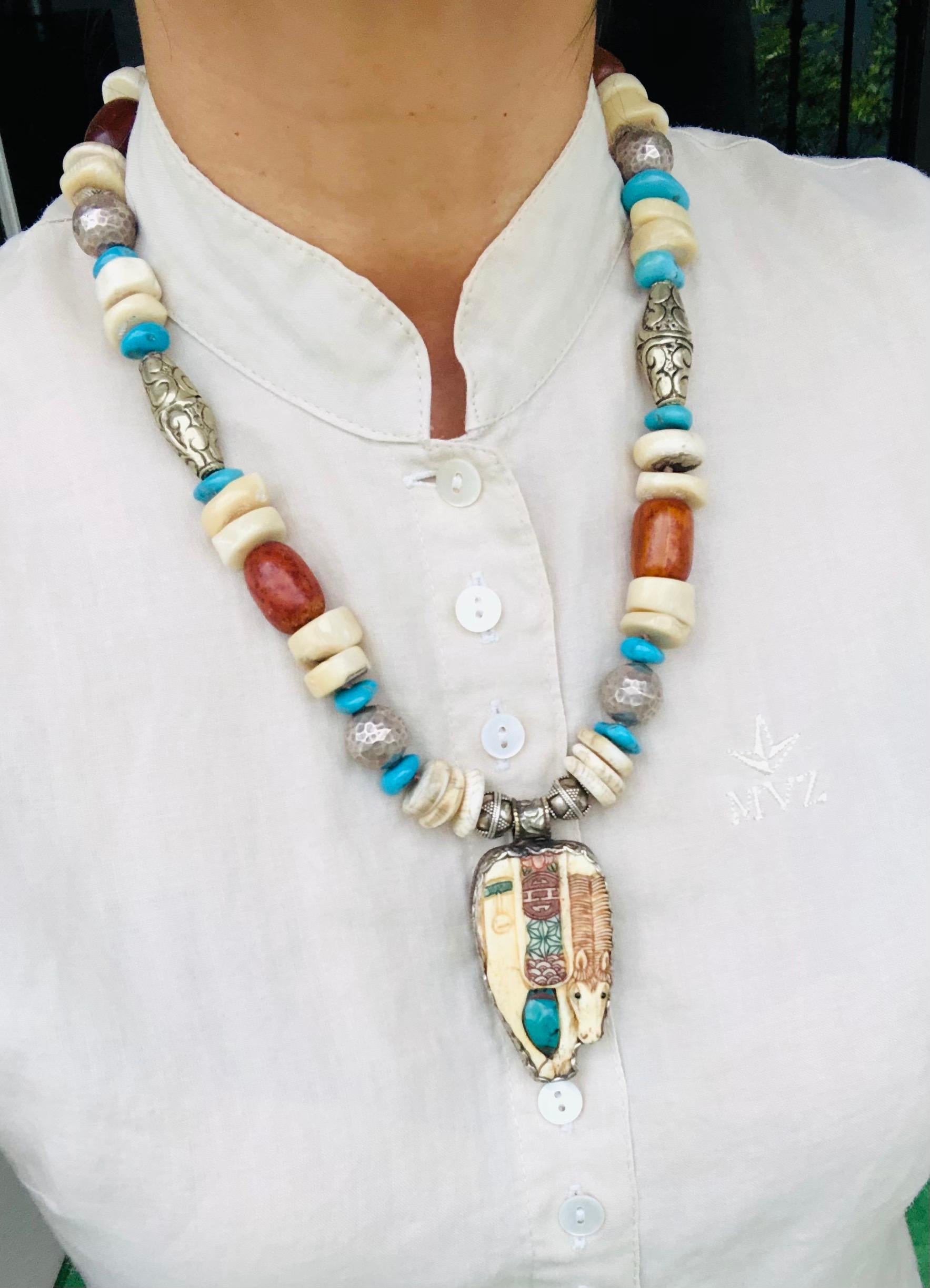 One-of-a-Kind
This is a beautifully elegant Necklace, carved bone Horse pendant hand-painted with Turquoise Wrapped in Sterling Silver. Assorted beads, Amber, Sea Bamboo, Sterling Silver, Turquoise, and Tibetan Beads make a truly unique and precious