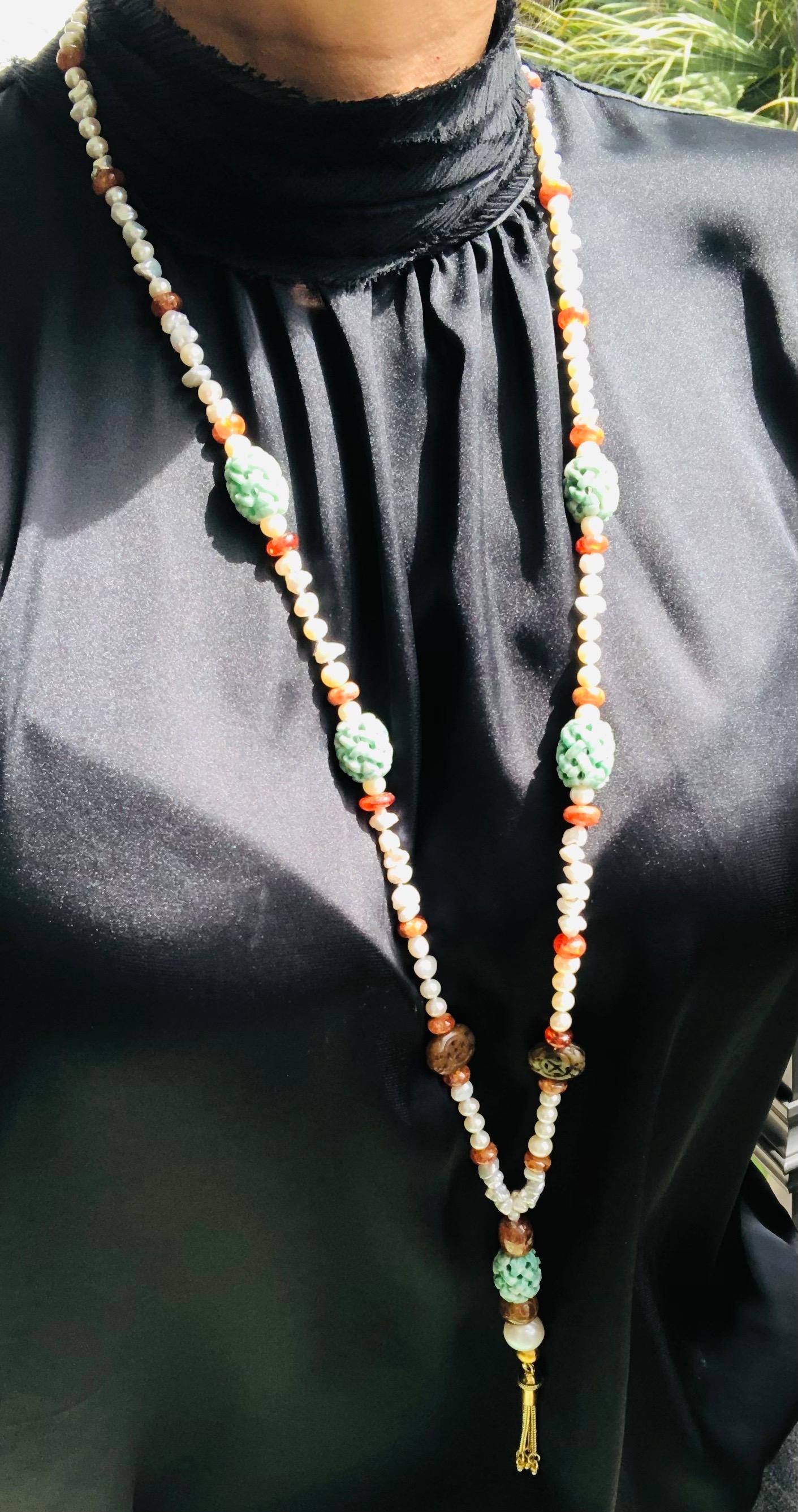 One-of-a-Kind
Wear-with-anything soft green and tobacco jade, creamy hessonite, and small baroque pearls combine in a one-of-a-kind necklace. 
The green jade is carved in the traditional melon pattern. The tobacco beads jade are carved flat