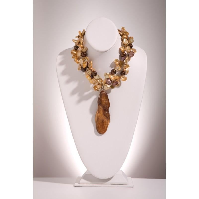 One-of-a-Kind
Fossilized scrimshaw walrus, champagne Keshi Pearls, chocolate Pearls combined into a statement necklace.
We start with an amazing 1000-year-old fossil carved and polished into a gorgeous, richly colored hand warmer. The pendant is