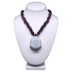 A.Jeschel  Garnet with a Jade carved Buddha pendant necklace.