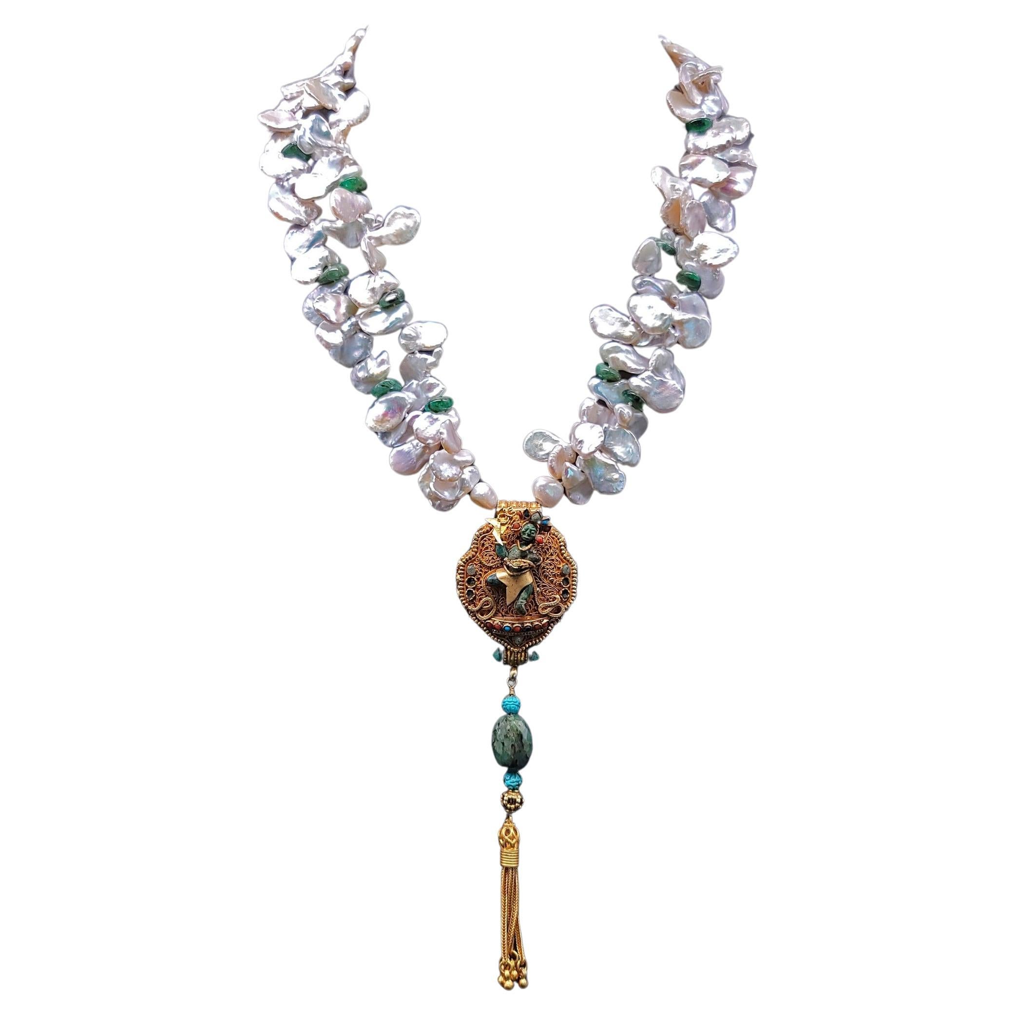 One-of-a-Kind
This sacred and elegant necklace centers around a traditional Tibetan ghau prayer box pendant, handcrafted by a monk in Tibet. The front features a carved emerald Buddha that opens to reveal a second hidden Buddha within—a powerful