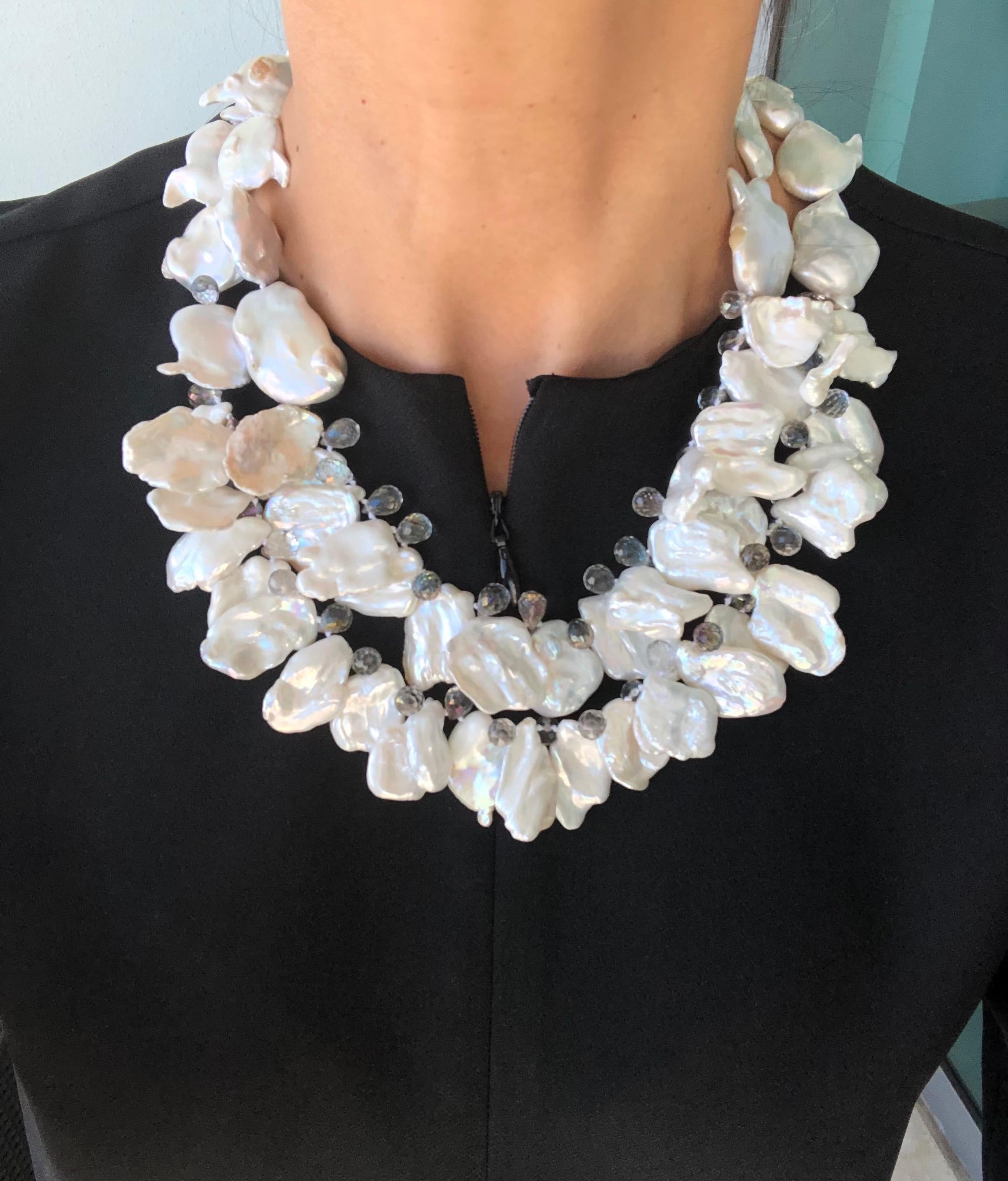 One-of-a-Kind 

Sometimes more is just enough. 
Like in this very flattering 2 strand necklace. 
Magnificent, high luster Baroque Pearls, nestle against each other to make a ruffle. Interspersed with faceted crystal teardrops to add a bit of sparkle