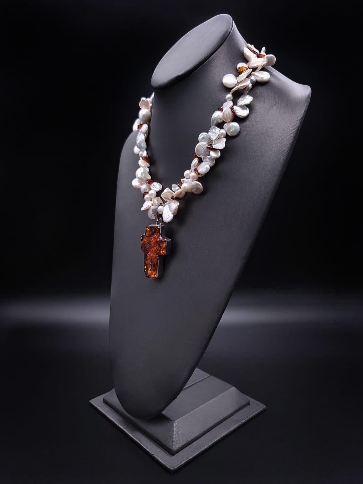 One-of-a-Kind

The two-strand Pearl and Amber necklace exude a captivating charm. The pearl strands intertwine gracefully, showcasing a mesmerizing blend of baroque, Keshi, and 6mm Pearls, resulting in an elegant, ruffled appearance. Peppered