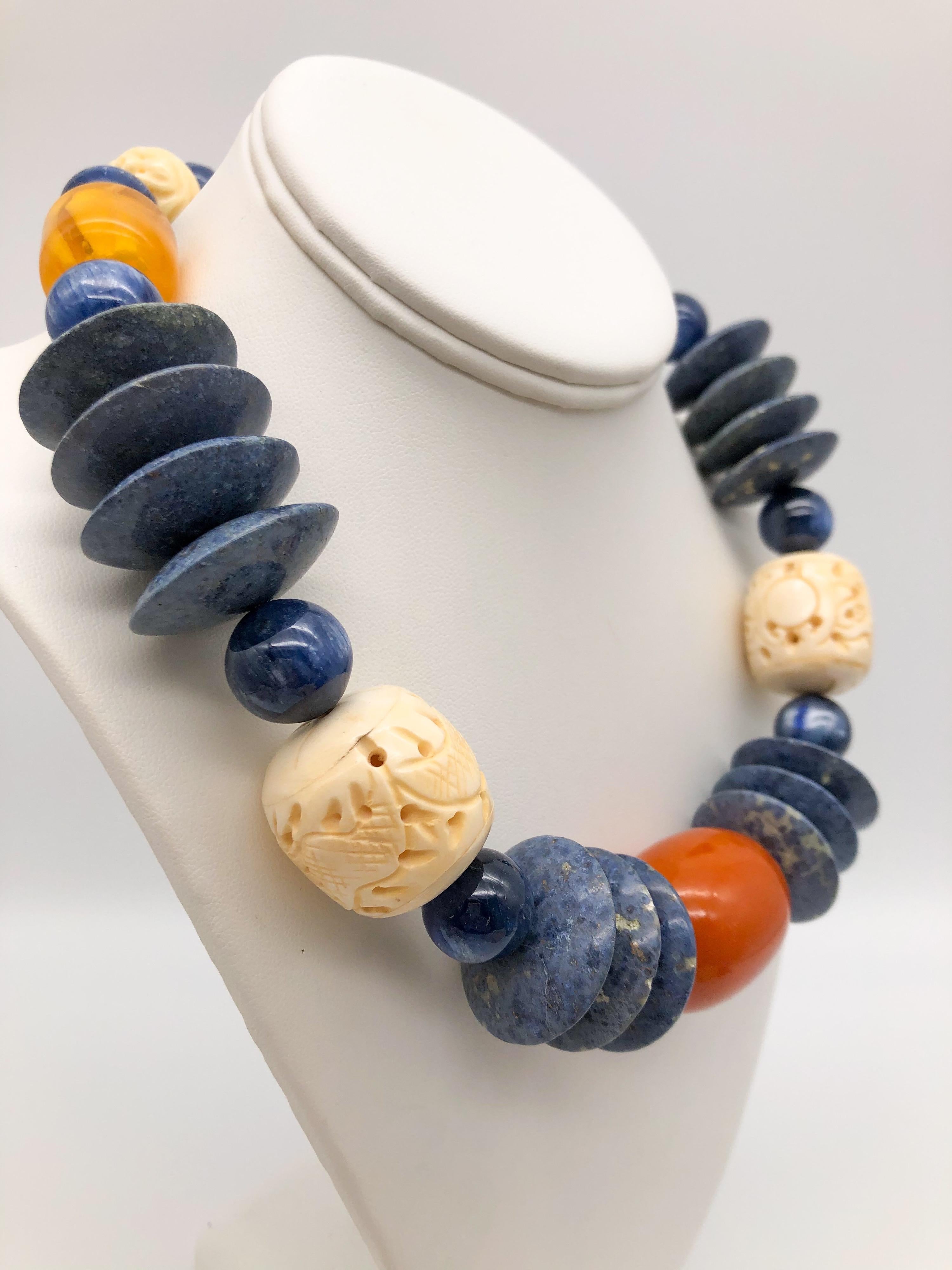One-of-a-Kind
Not to mention the carved Chinese bone that adds personality to the assemblage of round polished kyanite beads mixed with paler sodalite discs interspersed with Copal (amber of a certain age) and large carved Chinese beads. The clasp,