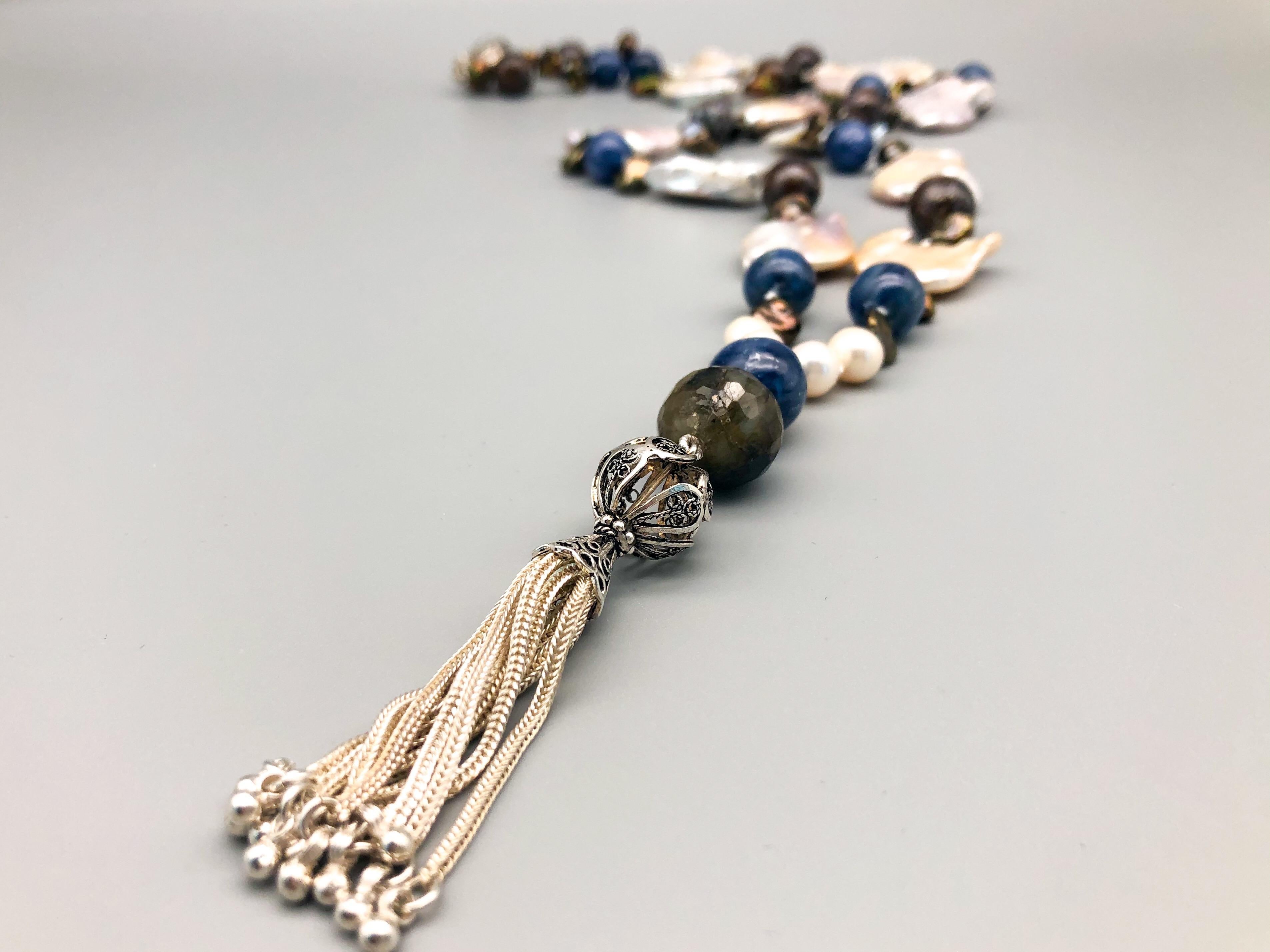 One-of-a-Kind
A fresh combination. mixes denim blue Kyanite and rich brown Australian Boulder opal separated by large baroque pearls. The pearls are of particular interest, as they are not only the familiar oddly shaped but flattened to maximize the