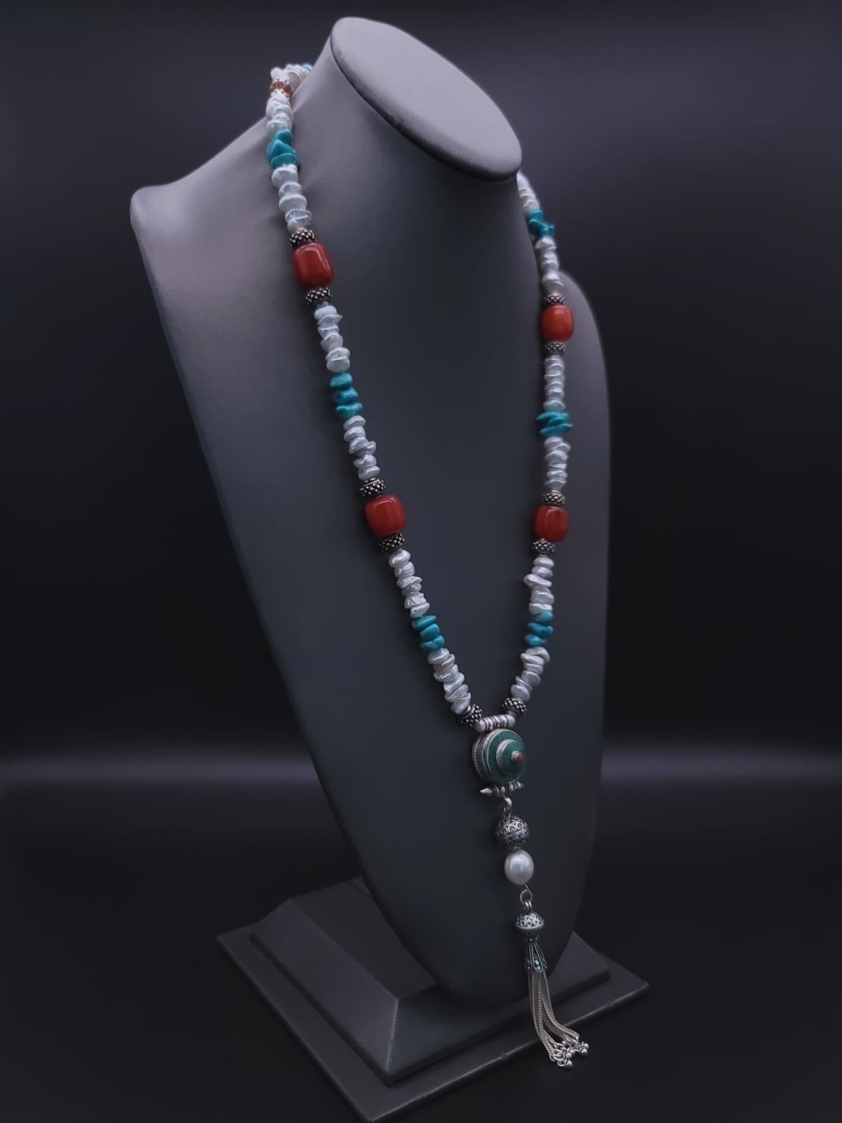 One-of-a-Kind

Inlaid with turquoise Long versatile “Y” necklace to wear with your summer whites. A melange of 8 m.m. Baroque pearls, American Beauty turquoise, red Copal, and decorative sterling silver beads meld in a 30” necklace. Anchored by a