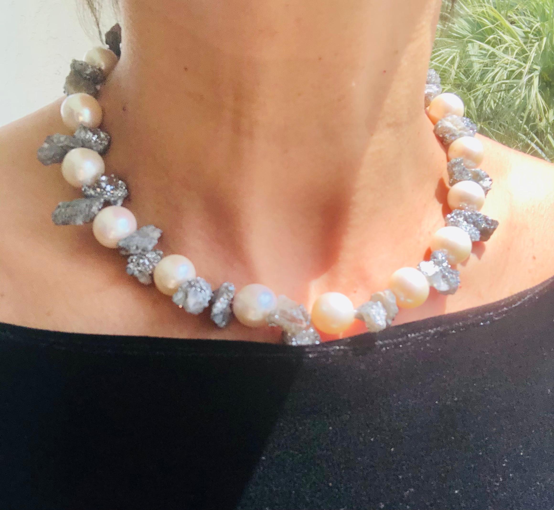 One-of-a-Kind

The glittery effect of tiny crystals on a rock fracture, in this case, Petercite, makes these druzy stones a perfect foil for the smooth textured pearls. Anchored by a vintage glass clasp that echos the colors of the Druzy. A necklace
