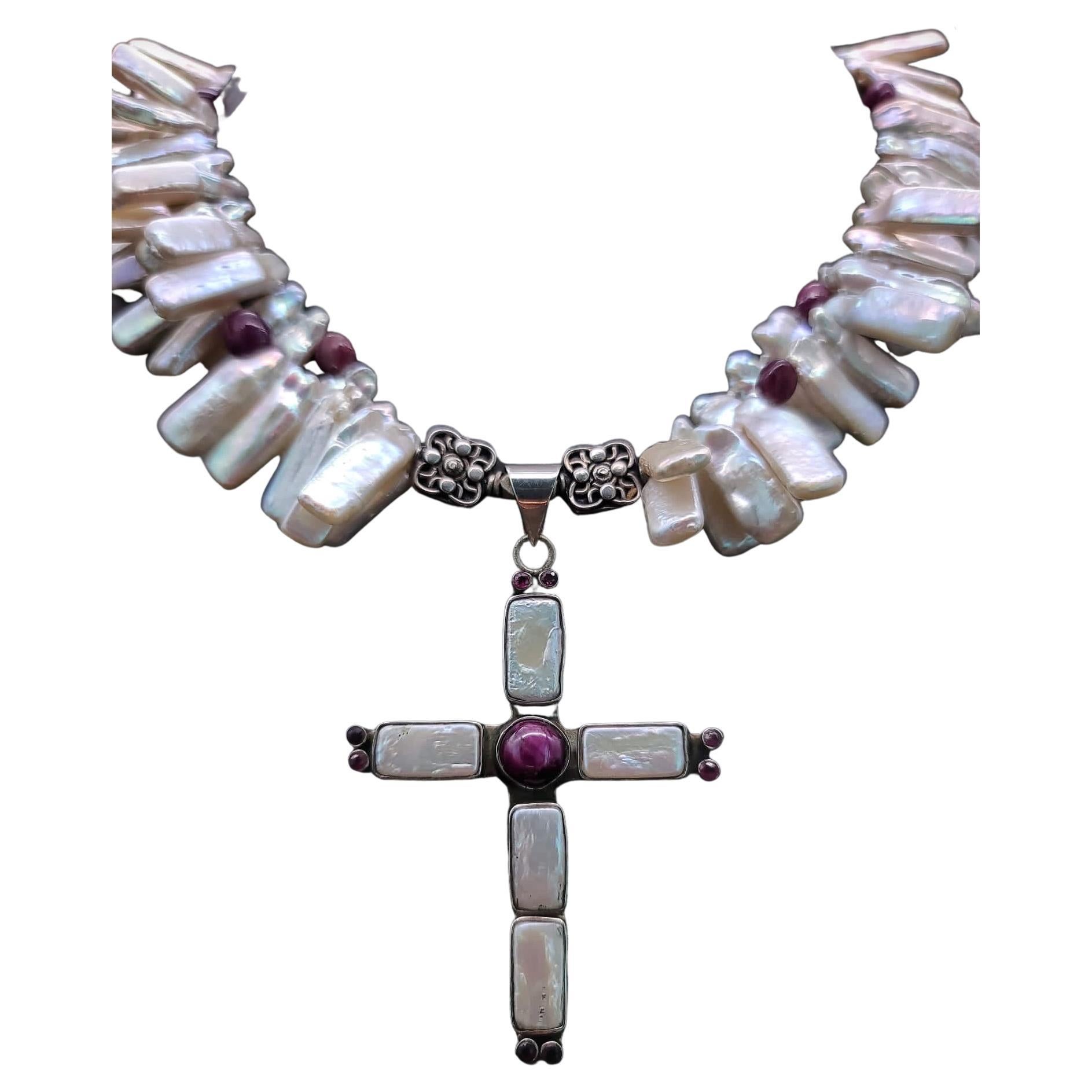 One-of-a-Kind

Not your ordinary cross necklace, but a flattering statement necklace of lustrous Pearls and Rubies paired with a lovely vintage cross.
Double-strand stick pearl and polished rubies make the perfect surround to an elegant cross of