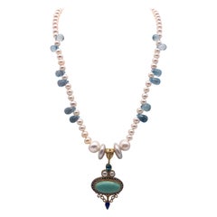 A.Jeschel  Collier de perles lustrées entre des topazes bleues et des gouttes de larmes.