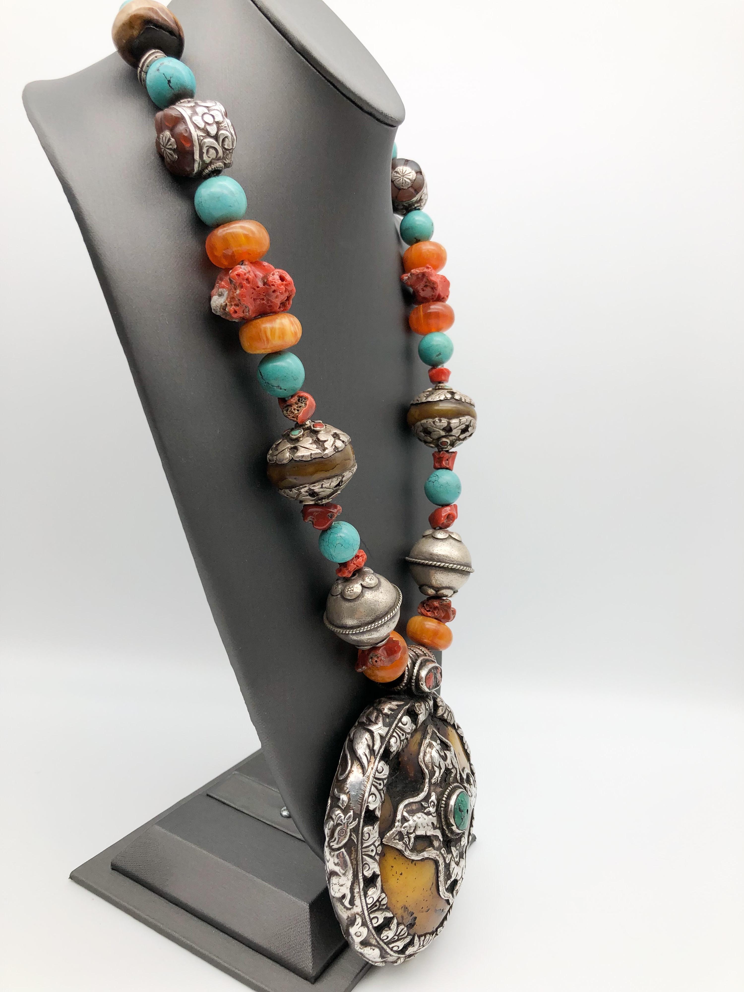 One-of-a-Kind

This is an exquisitely crafted Dramatic and Bold Amber set in Sterling Silver Tibetan Pendant. Sterling Silver cross design center and Turquoise decoration. Tibetan artists always include animals and flowers in their designs. Sterling