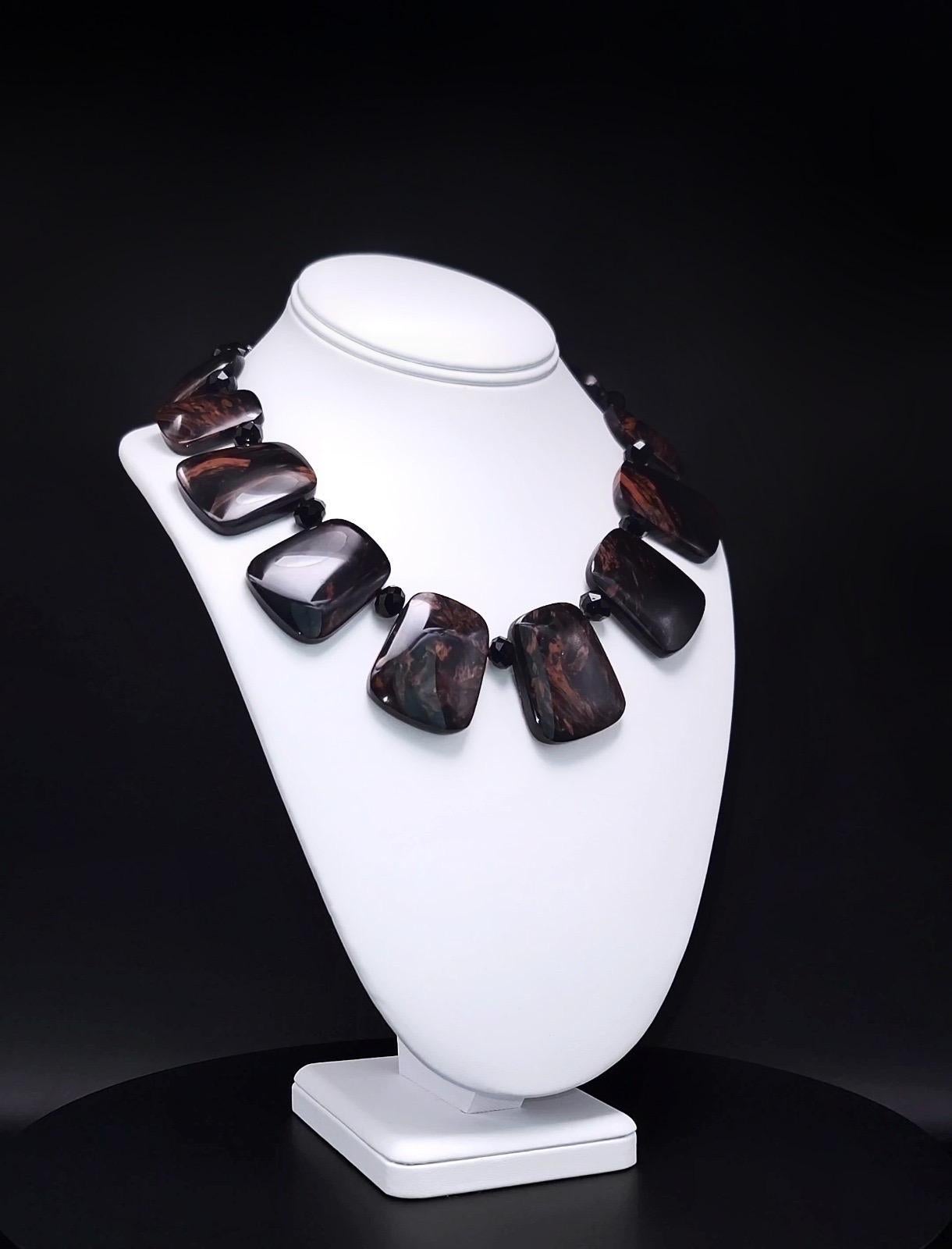 Questa collana unica nel suo genere è caratterizzata da straordinarie placche di ossidiana messicana, ognuna delle quali mostra colori ricchi e profondi con vortici e motivi naturali. Le piastre di ossidiana sono annodate a mano con la seta, per