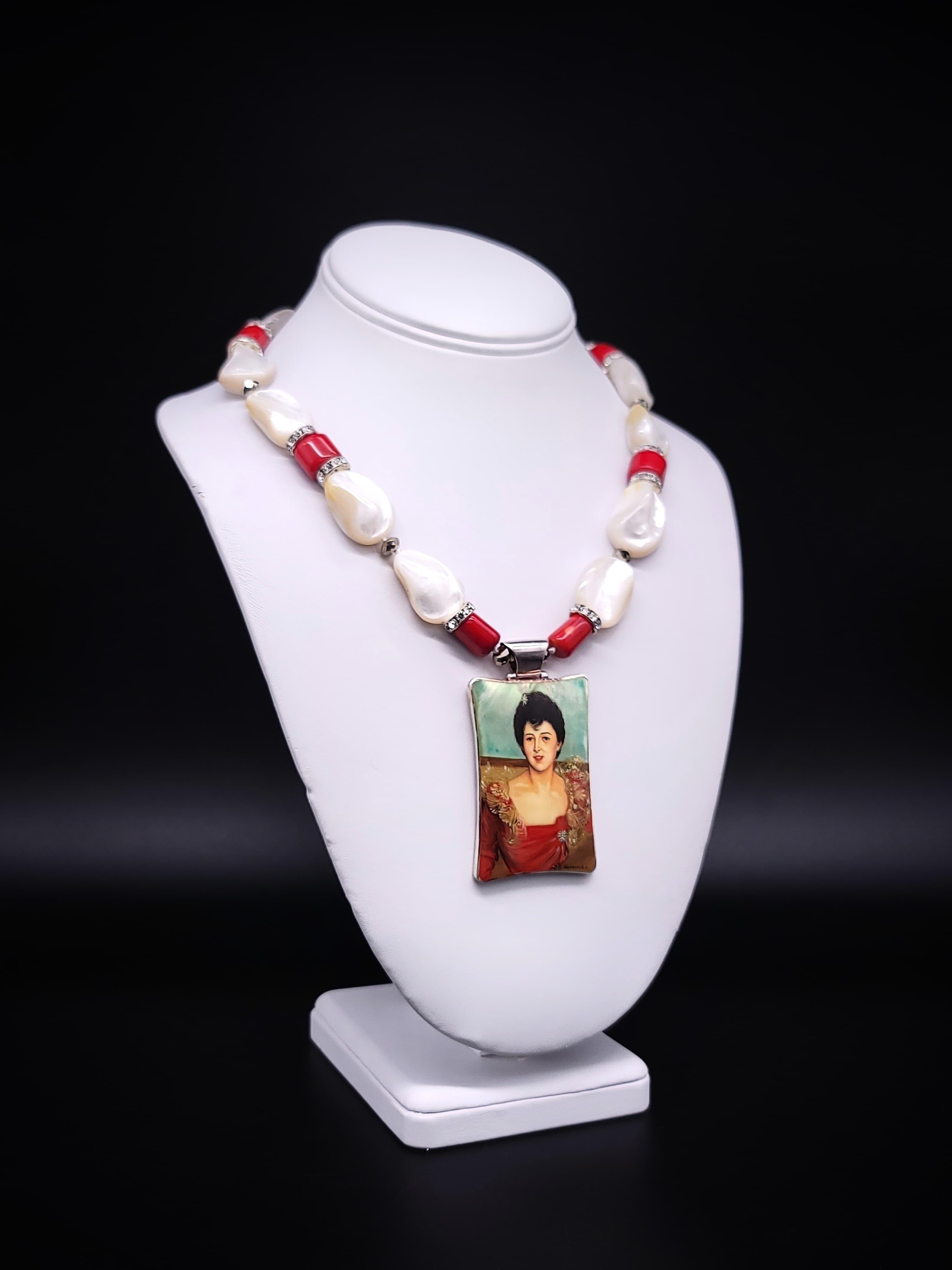 One-of-a-Kind

Introducing a truly captivating and sophisticated jewelry piece - a necklace adorned with lustrous mother-of-pearl beads elegantly accented with coral, and a mesmerizing pendant featuring a beautiful image of Mrs. Hugh