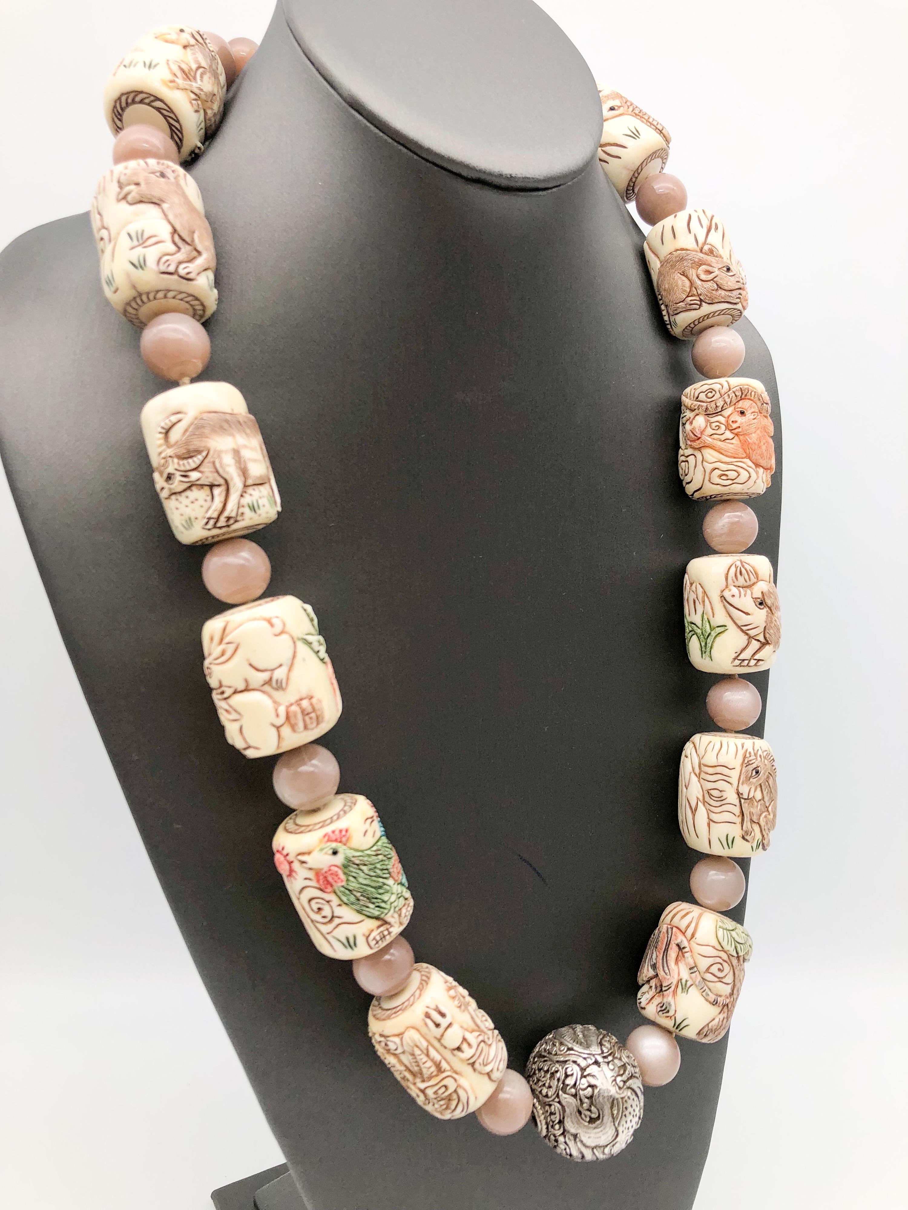 One-of-a-Kind
This is a Vintage carved bone Chinese zodiac necklace. Hand-painted 12-month of different animals for each month, the zodiac are spaced with 12-14mm Moonstone beads. Carved Sterling Silver 