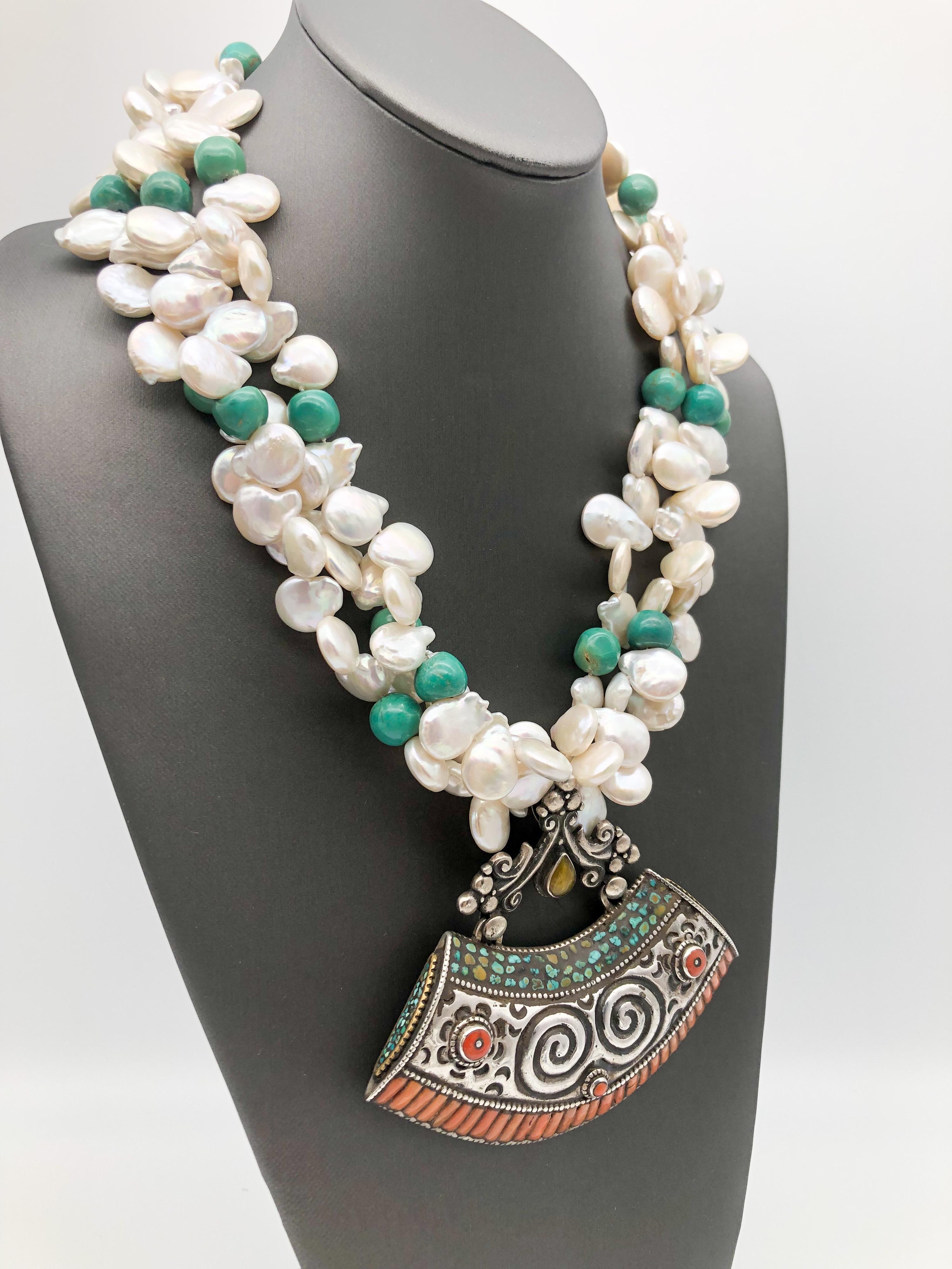 One-of-a-Kind
3 Strand Freshwater Pearl necklace spaced with 12mm Turquoise beads. This fabulous Tibetan Pendant was hand-made from Sterling Silver and decorated with Turquoise and Tibetan mosaic, the craftmanship in the back is especially