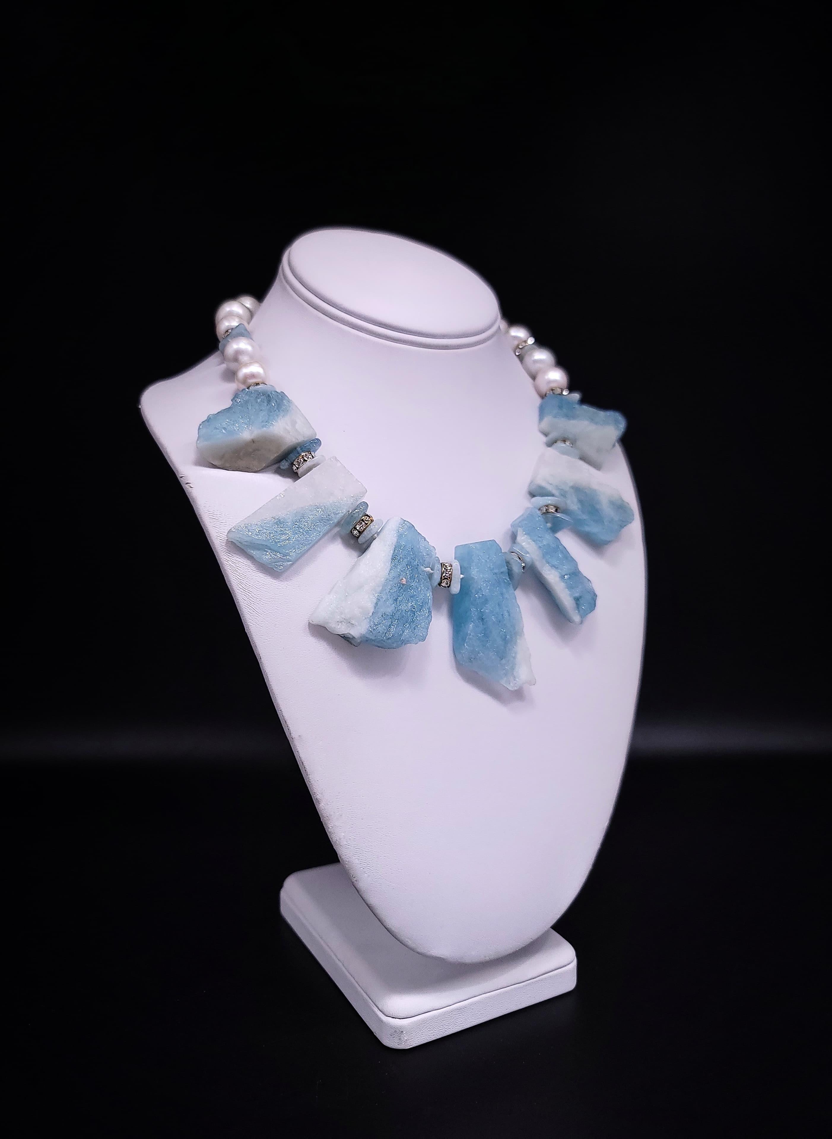 Unique Aquamarine Elegance: Handcrafted Statement Necklace

Prepare to be mesmerized by the singular beauty of this one-of-a-kind necklace, meticulously crafted to captivate the senses. Seven rough-cut flat-back aquamarine chunks steal the