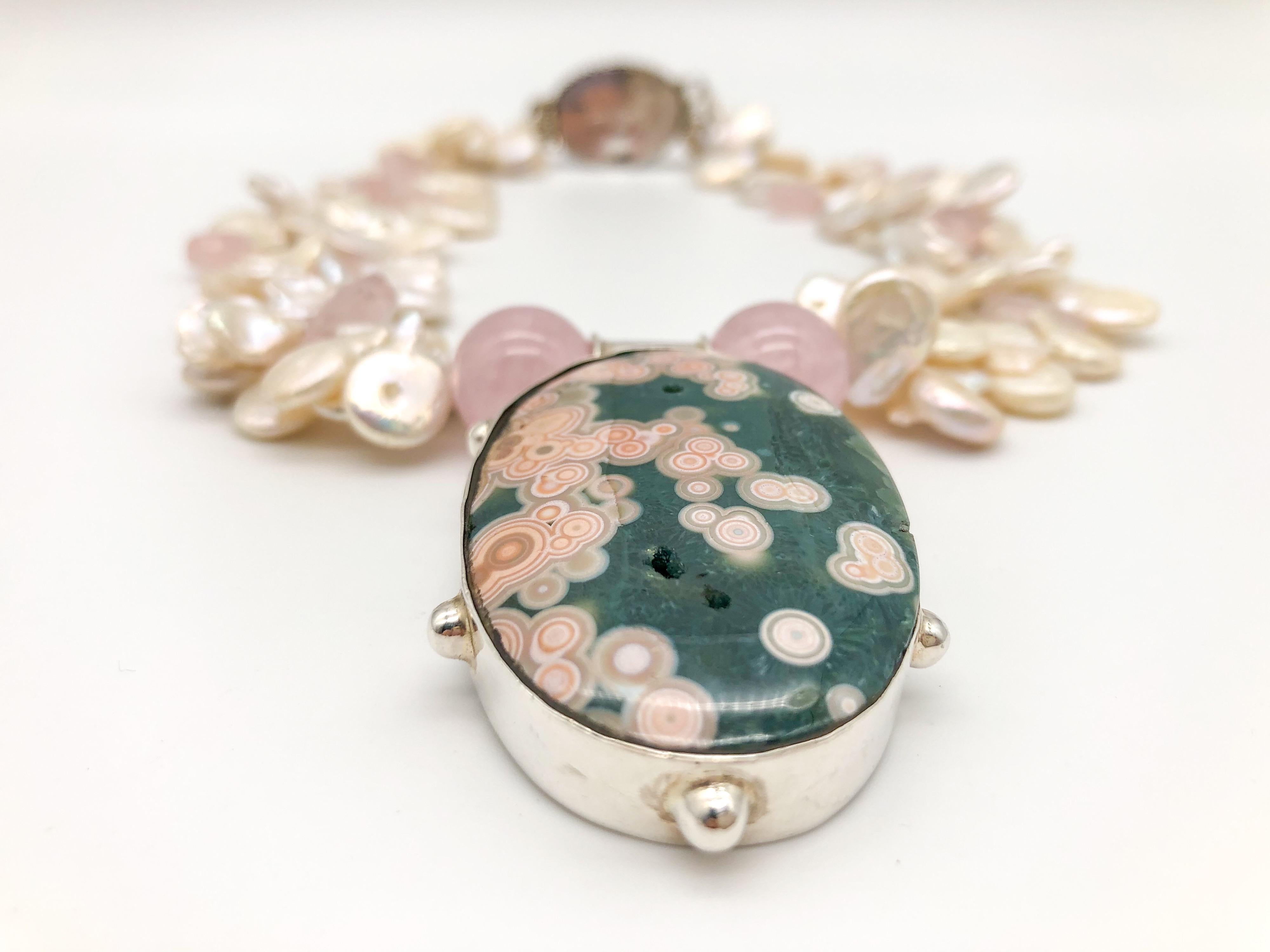 One-of-a-Kind
2 strand necklace
The polished rose quart softly compliments the pink clusters in the Jasper stone. The top-drilled petal pearls interspersed with rose Quartz faceted drops and to the overall elegance of the necklace. The clasp is